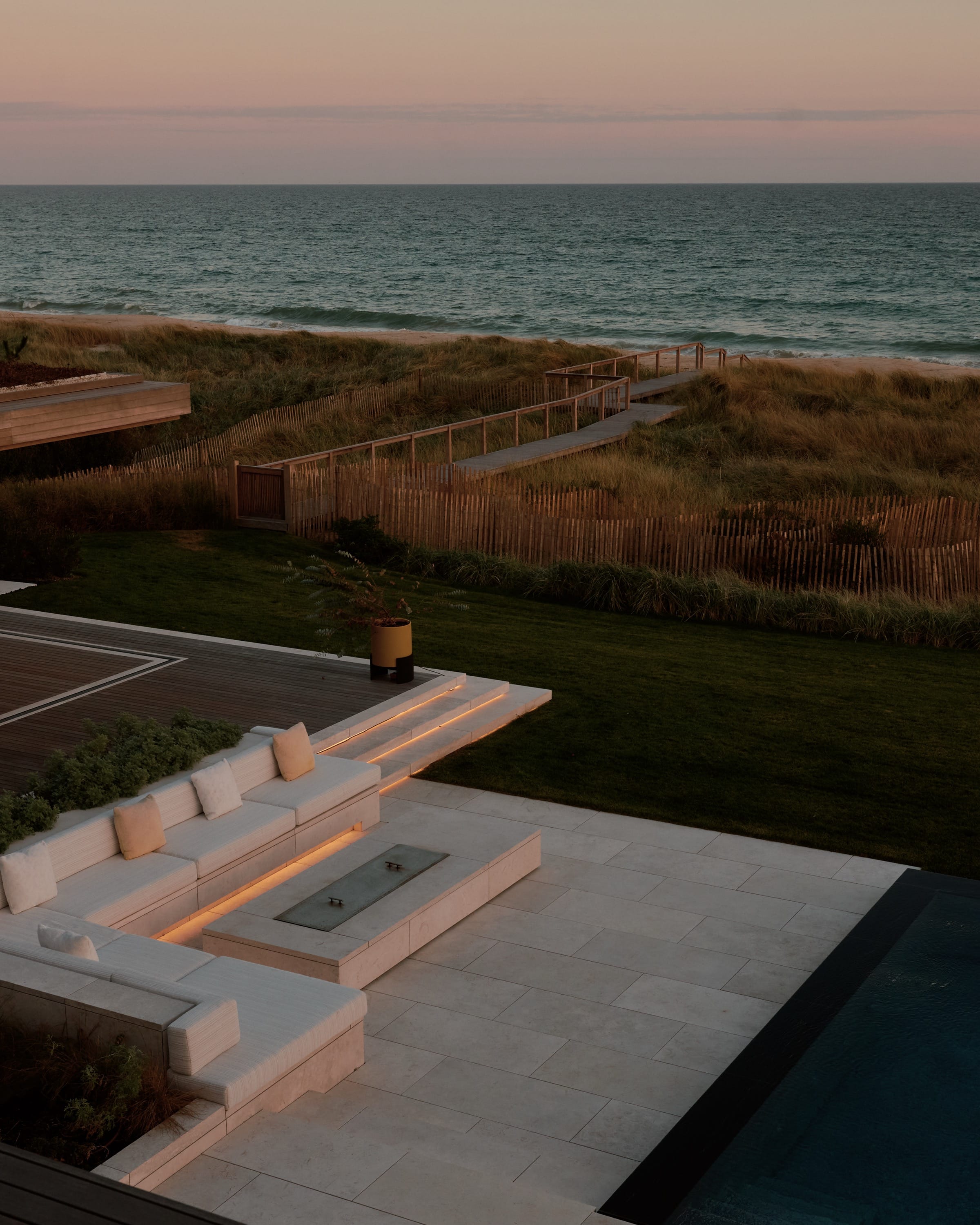 Terrace with pool, seating, and ocean view.