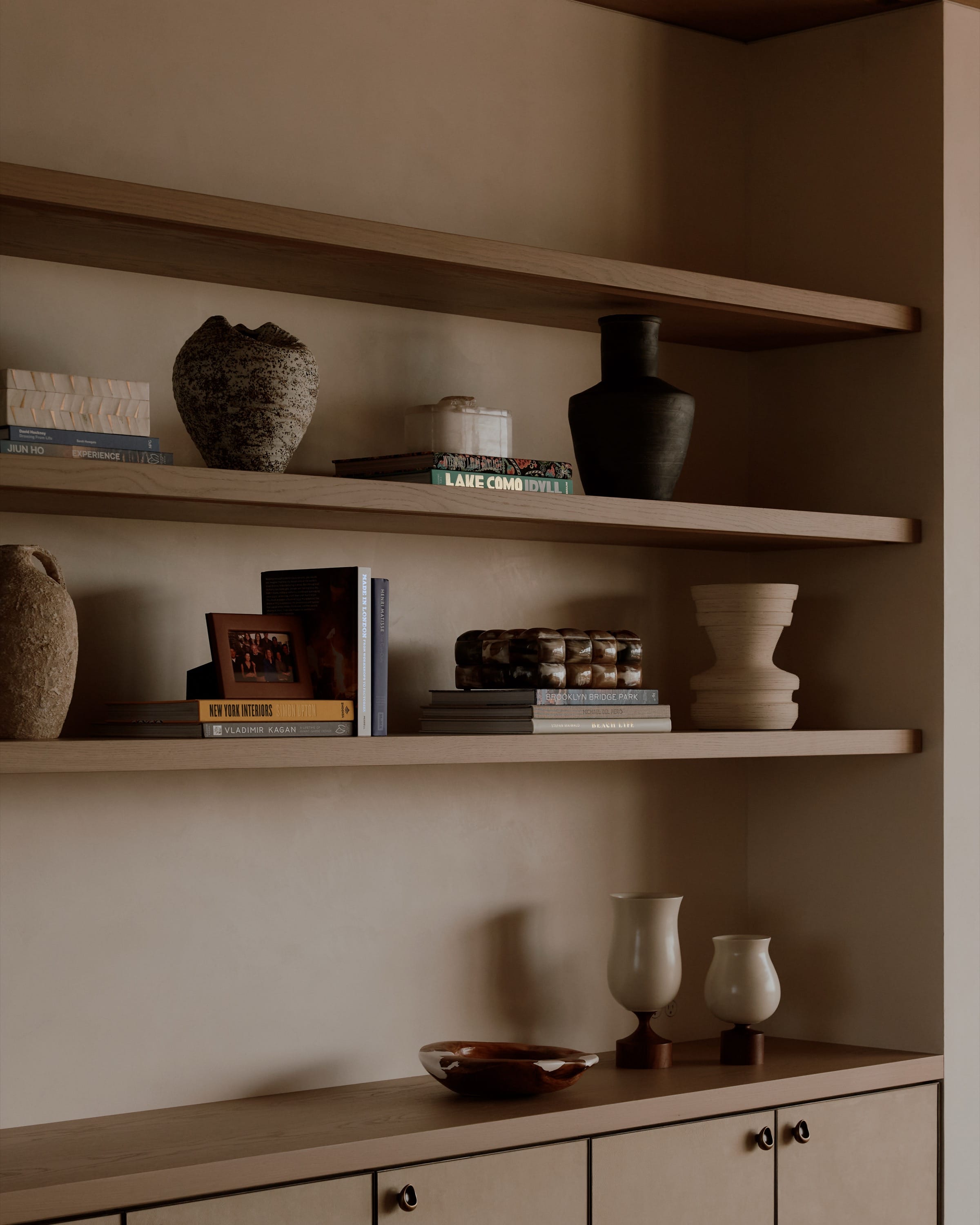 Built-in shelving with ceramics and decor accents.