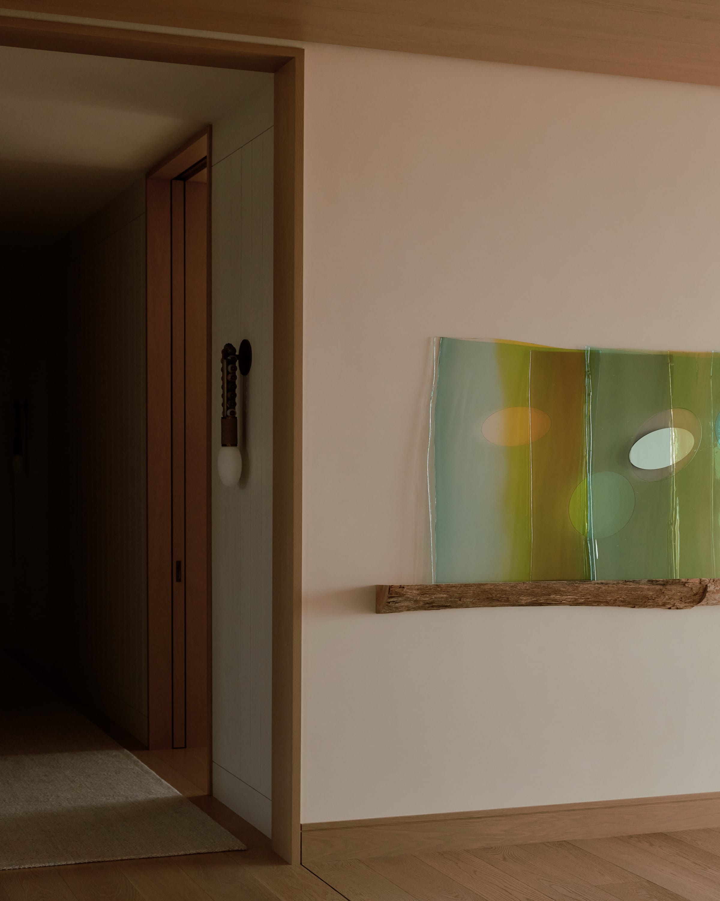 Hallway with wooden floors and abstract painting.