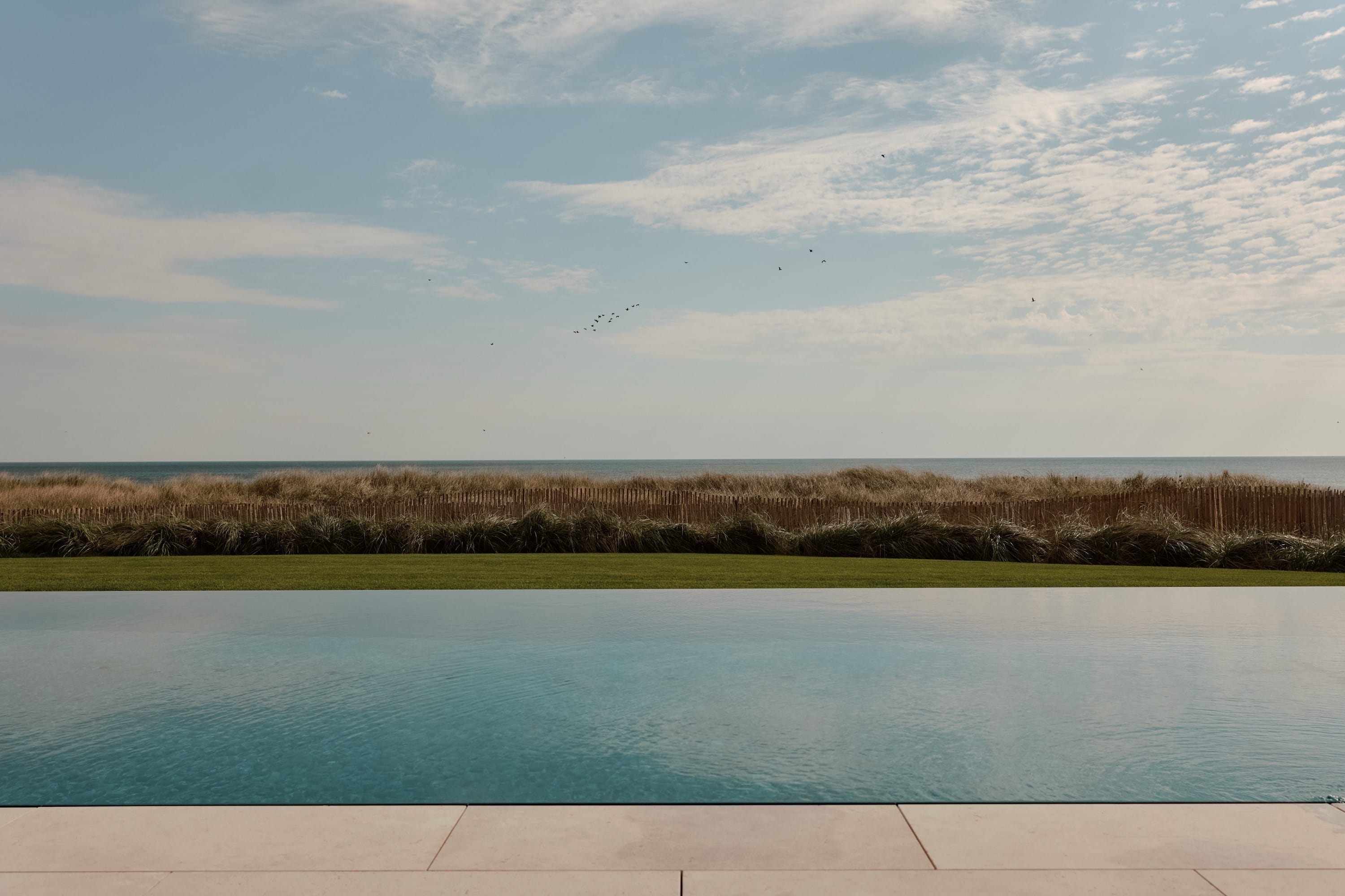 Backyard with pool and expansive landscape view.