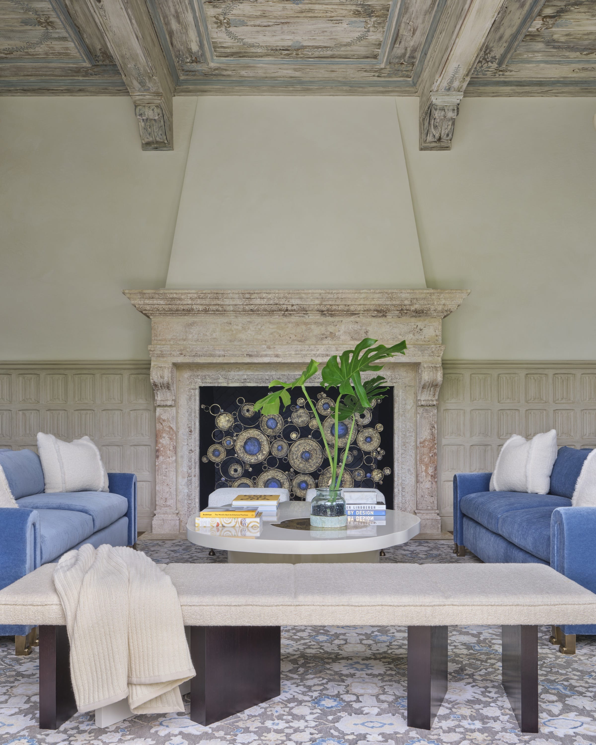 Stone fireplace with floral artwork and neutral seating.