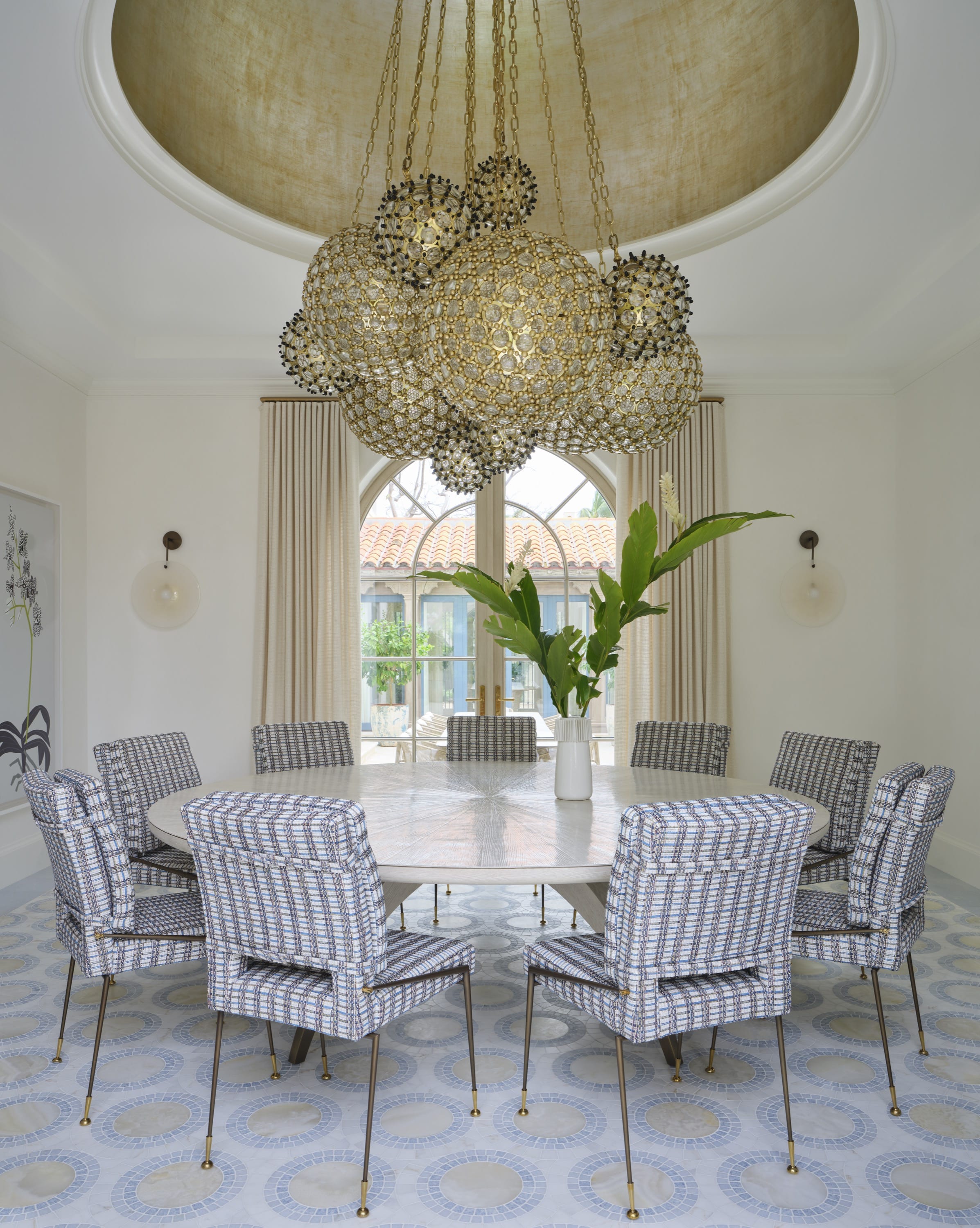 Dining room with round table and woven pendant lights.