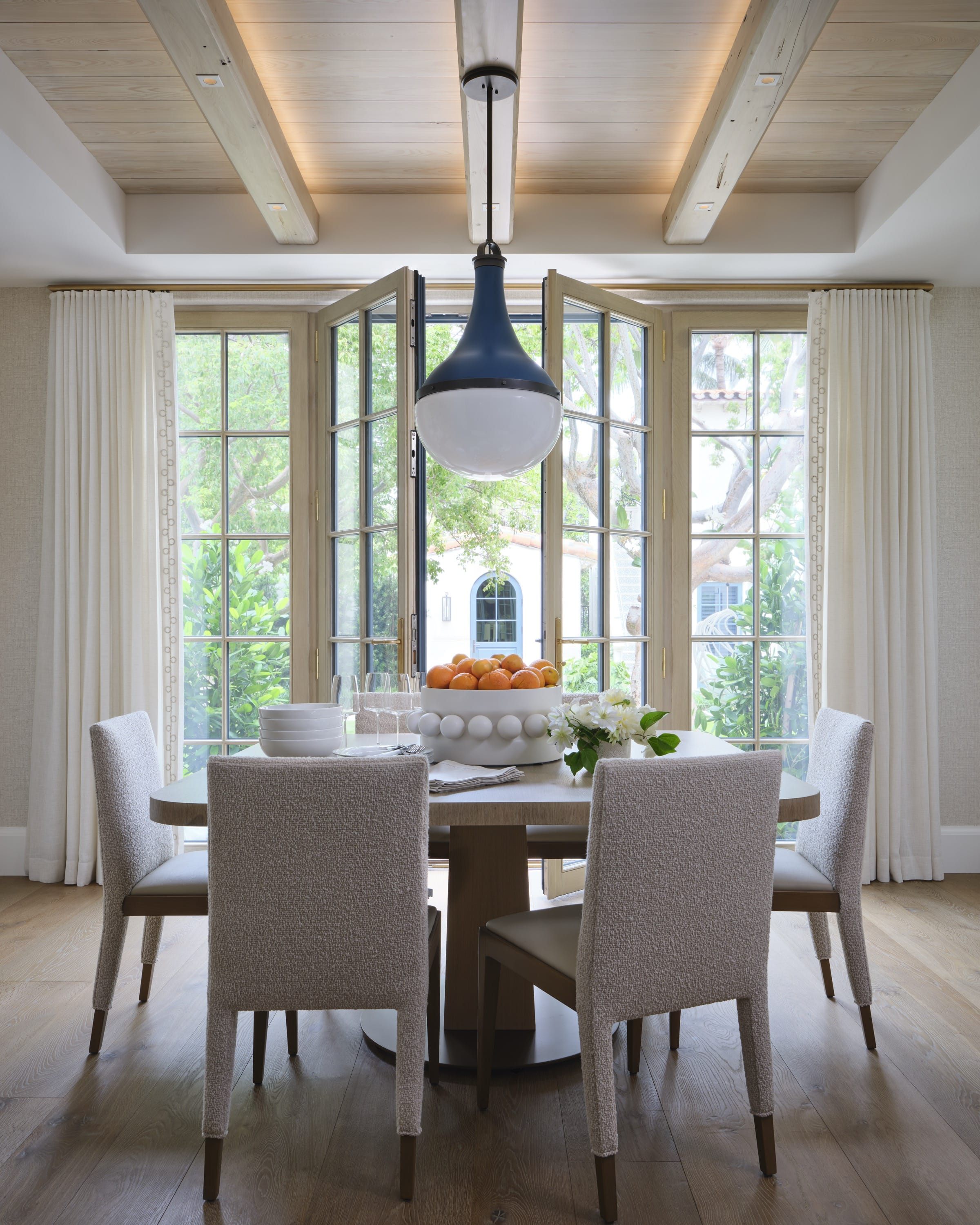 Dining room with rectangular table and wood ceiling.