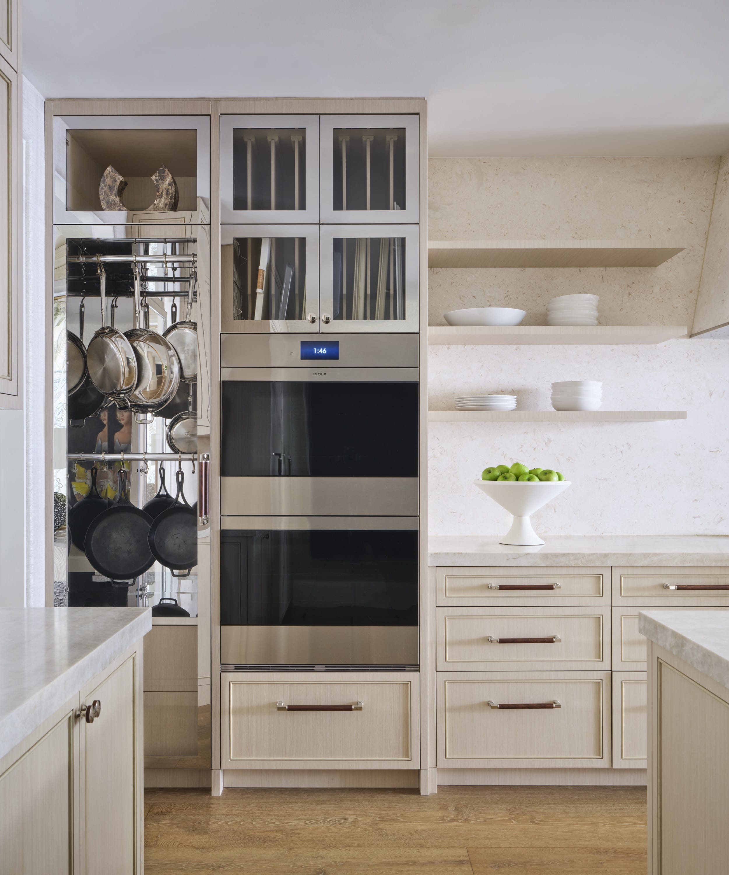 Kitchen with built-in ovens and light cabinetry.