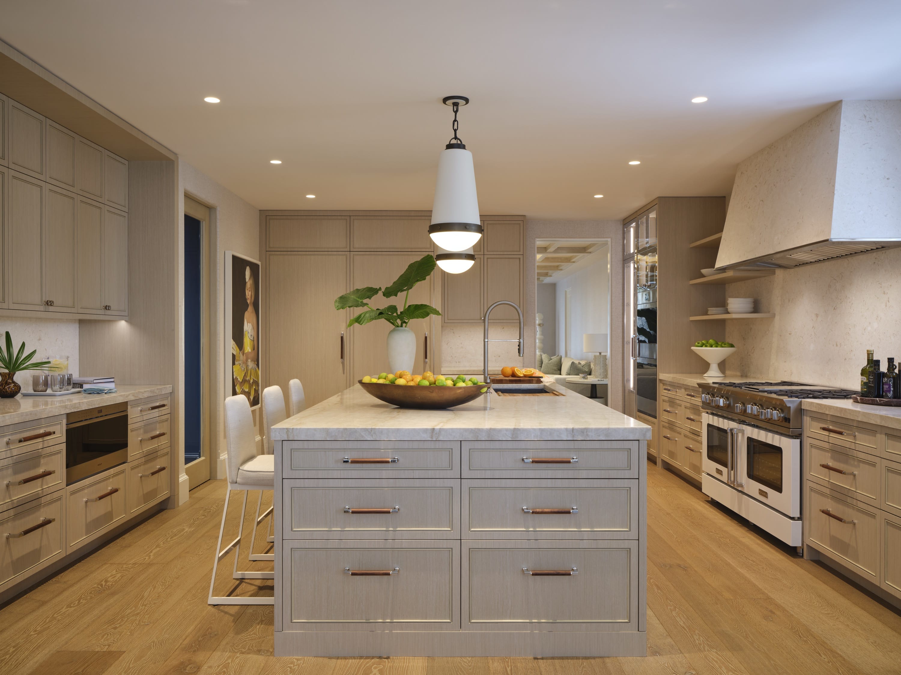 Kitchen with long island, wood flooring, and pendant lighting.