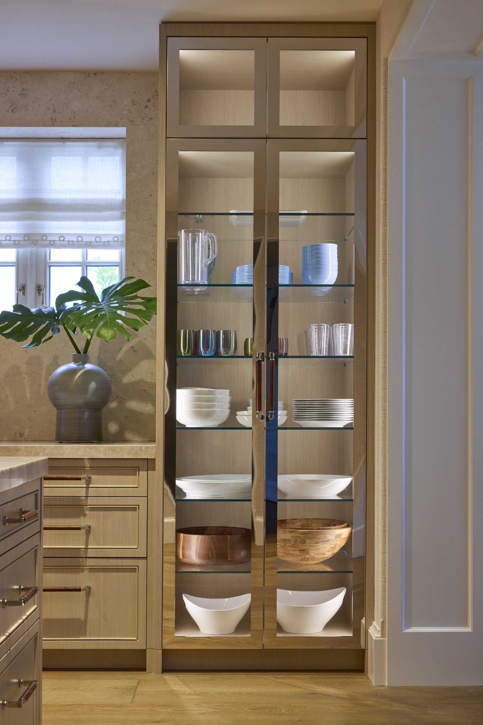 Wine cellar with wood racks and glass doors.