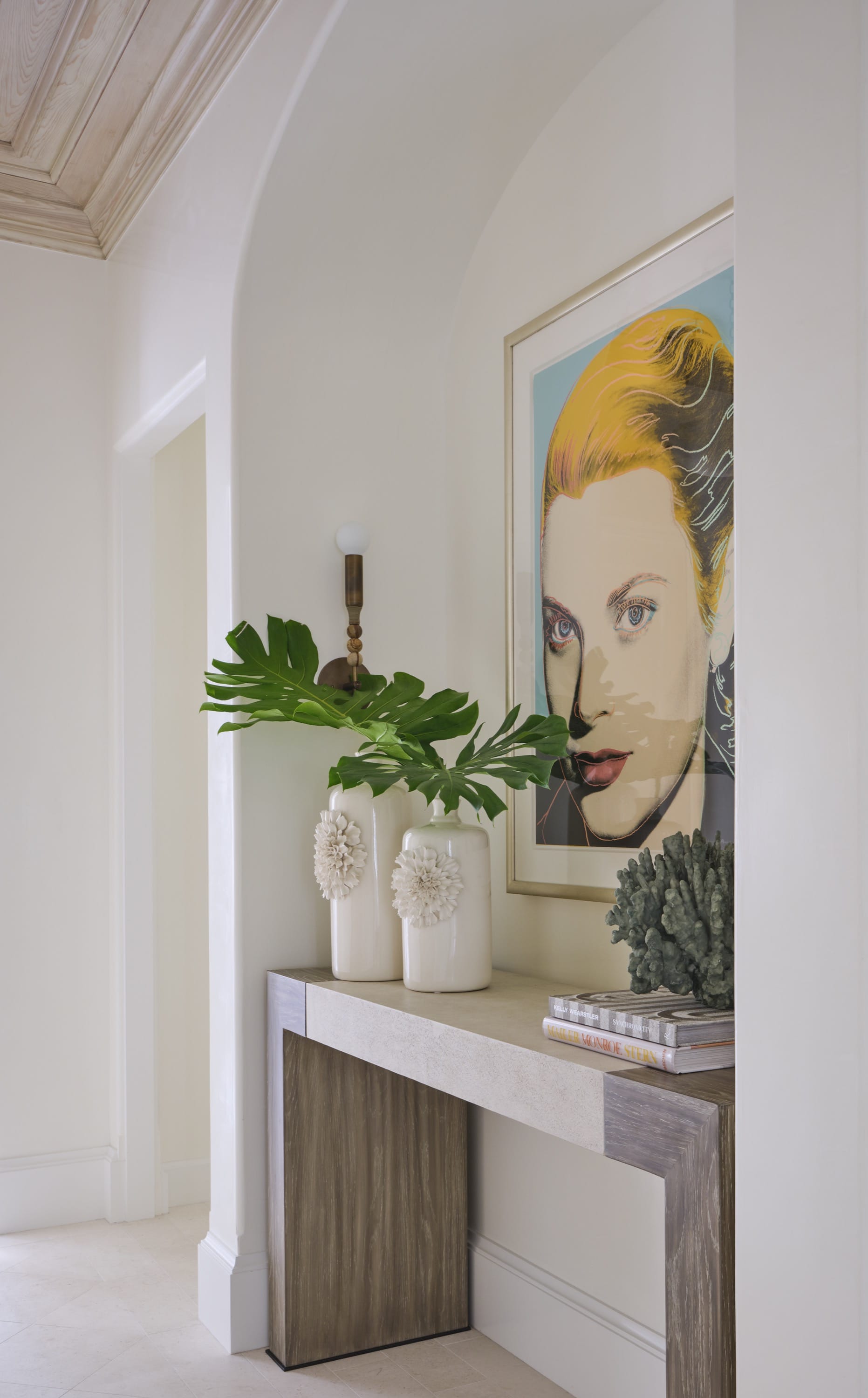 Hallway with portrait artwork and console table.