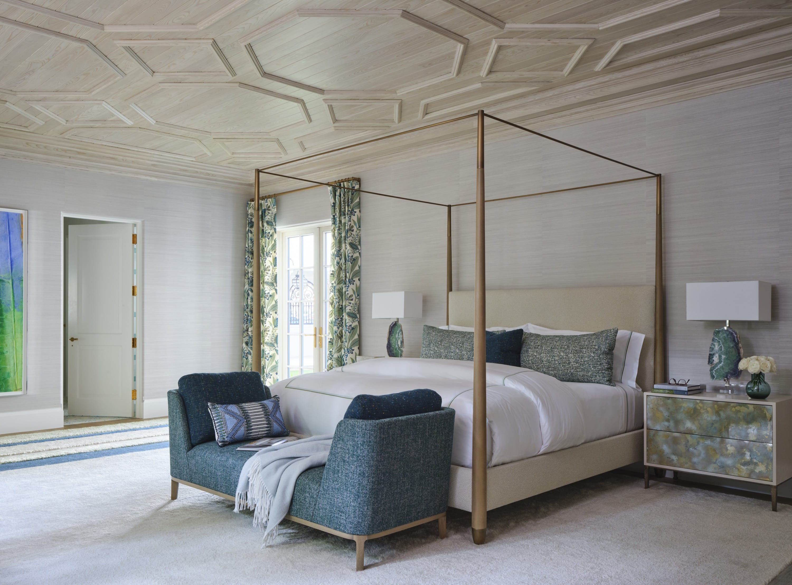 Bedroom with four-poster bed and sitting area.