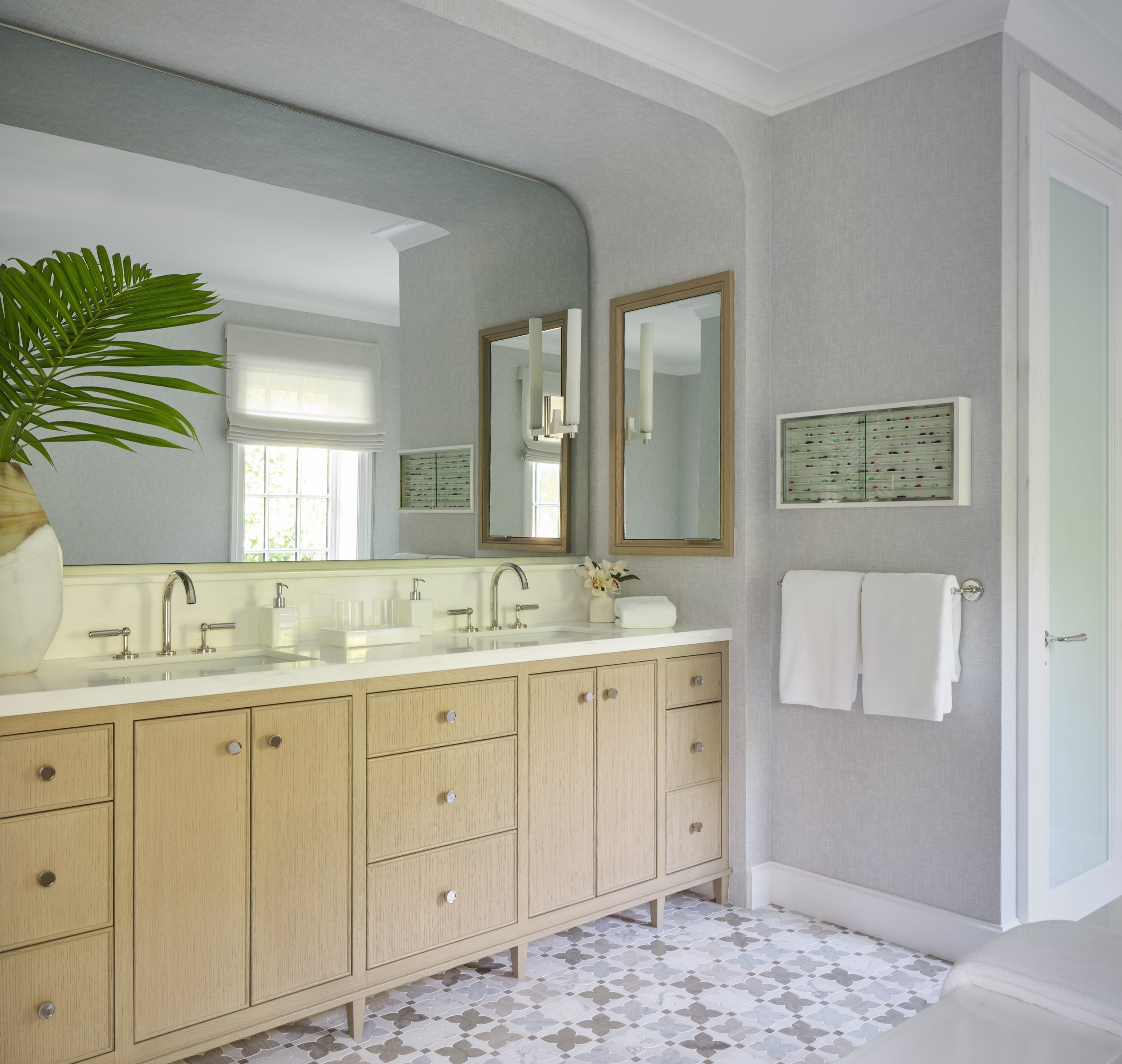 Bathroom with double vanity and large mirrors.
