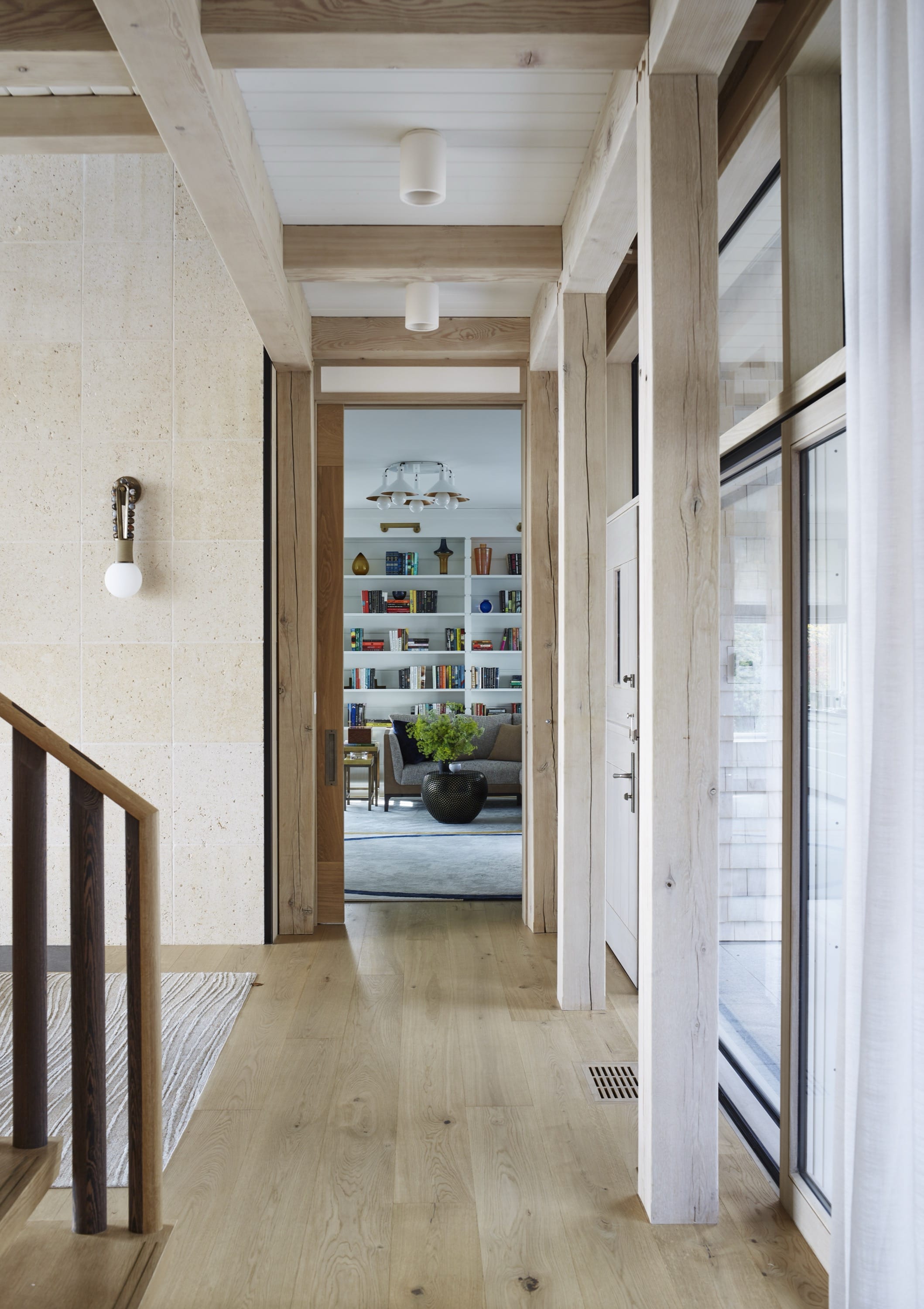 Hallway with wood flooring and stair railing.