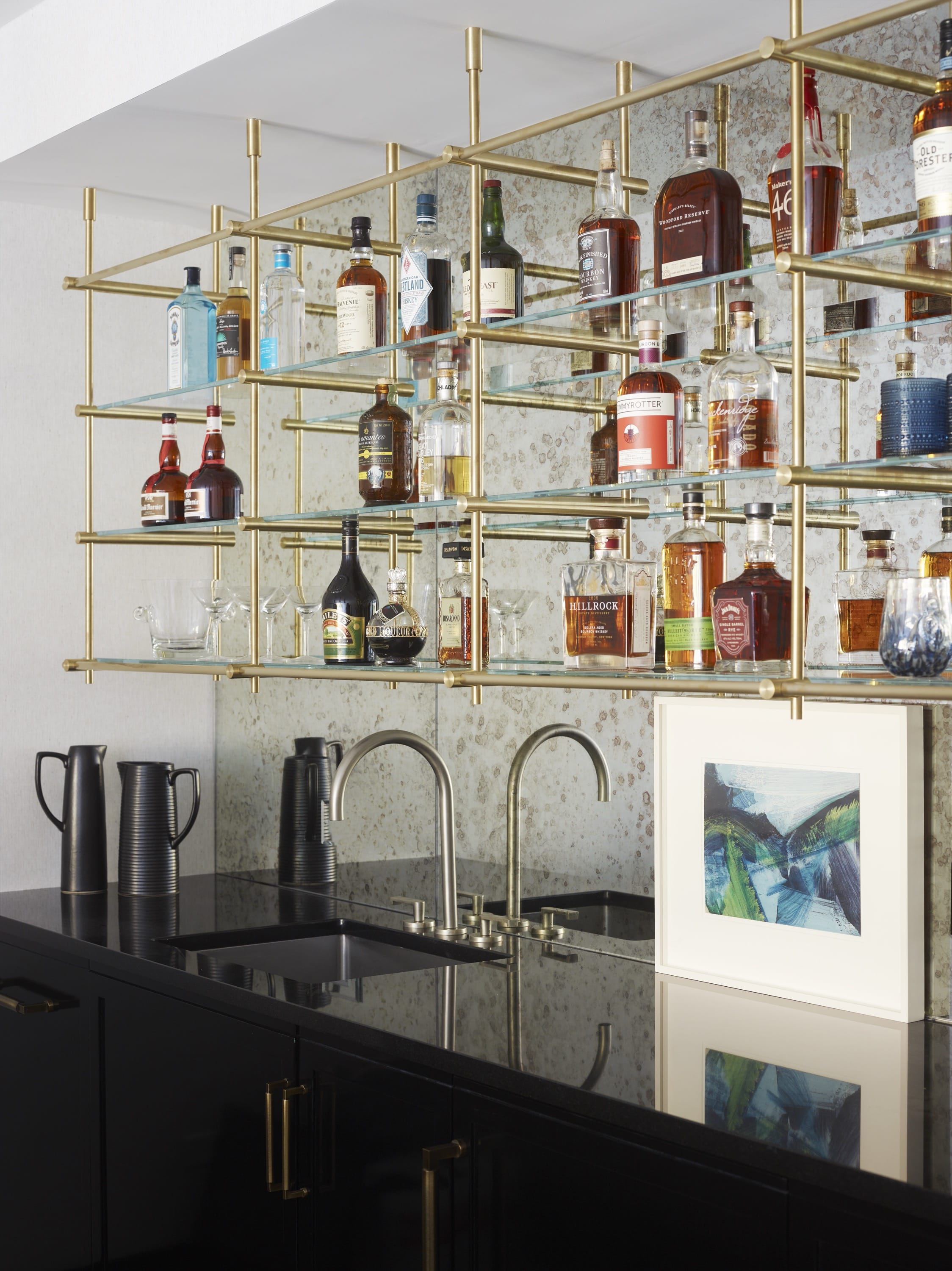 Home bar with mirrored shelving and liquor display.