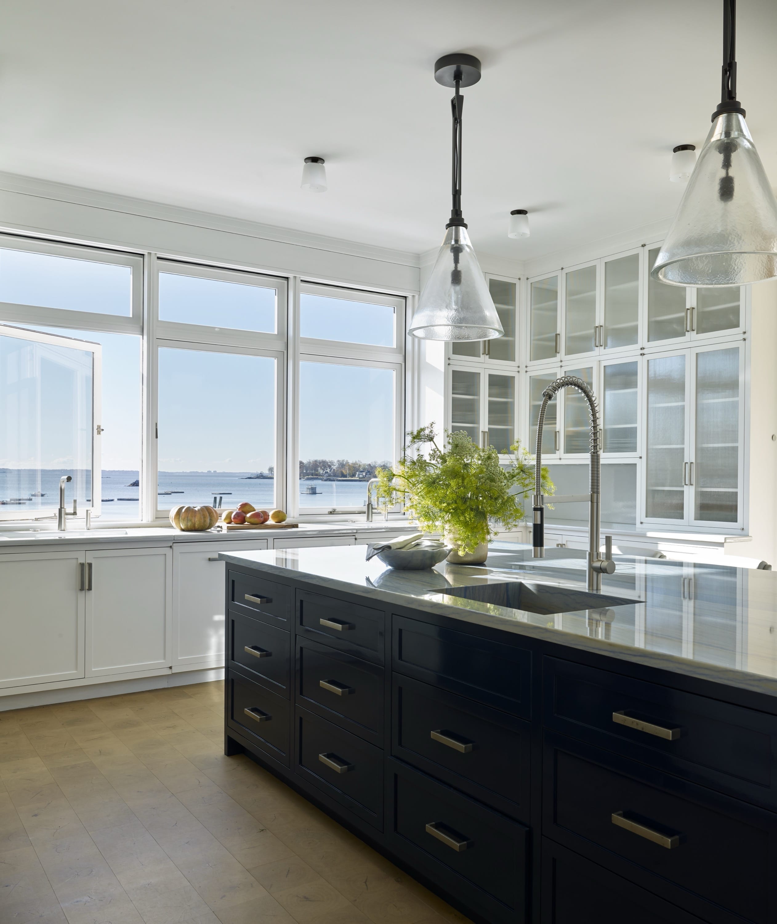 Kitchen with dark island and panoramic windows.
