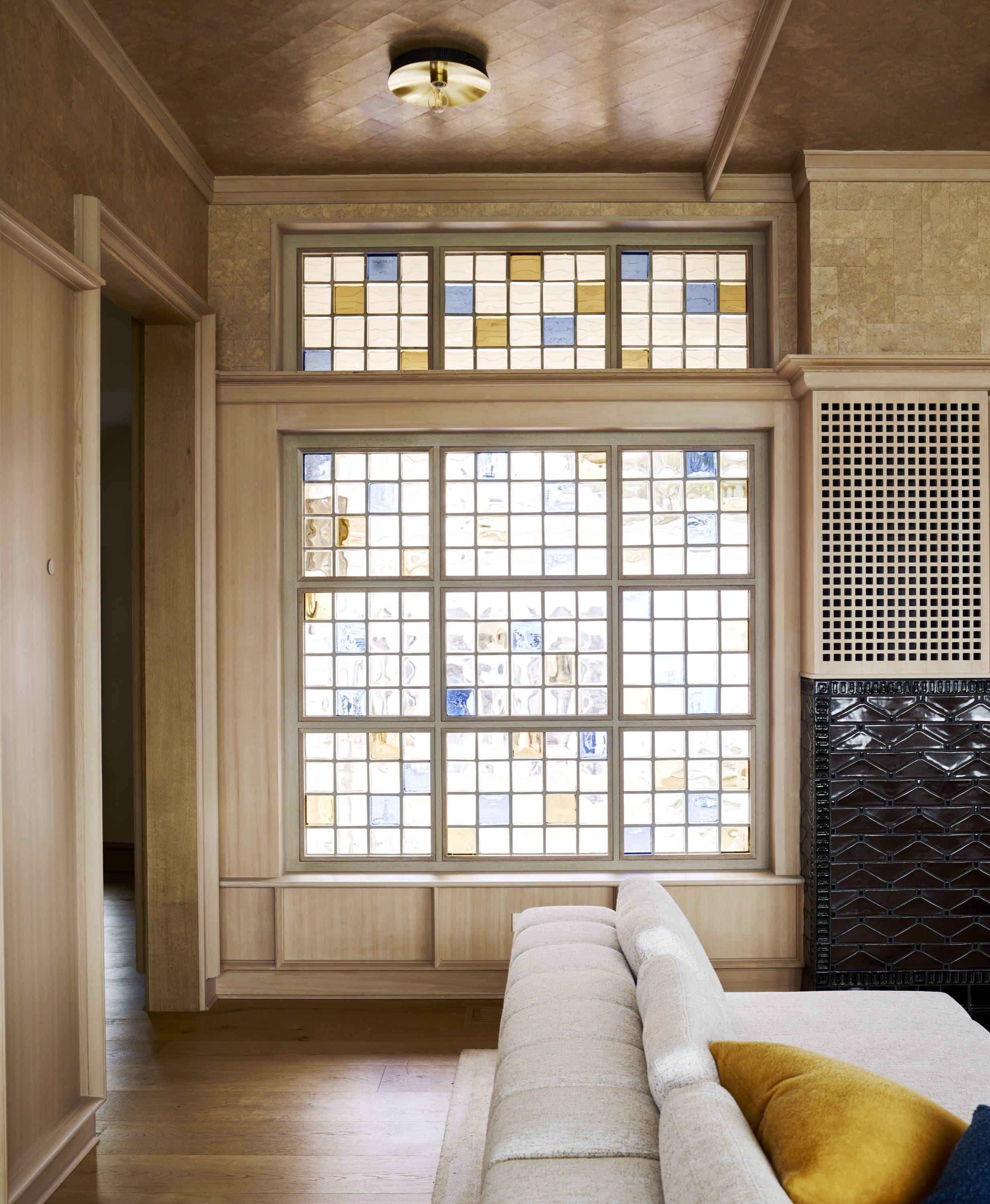 Entryway with wood door and patterned glass panels.