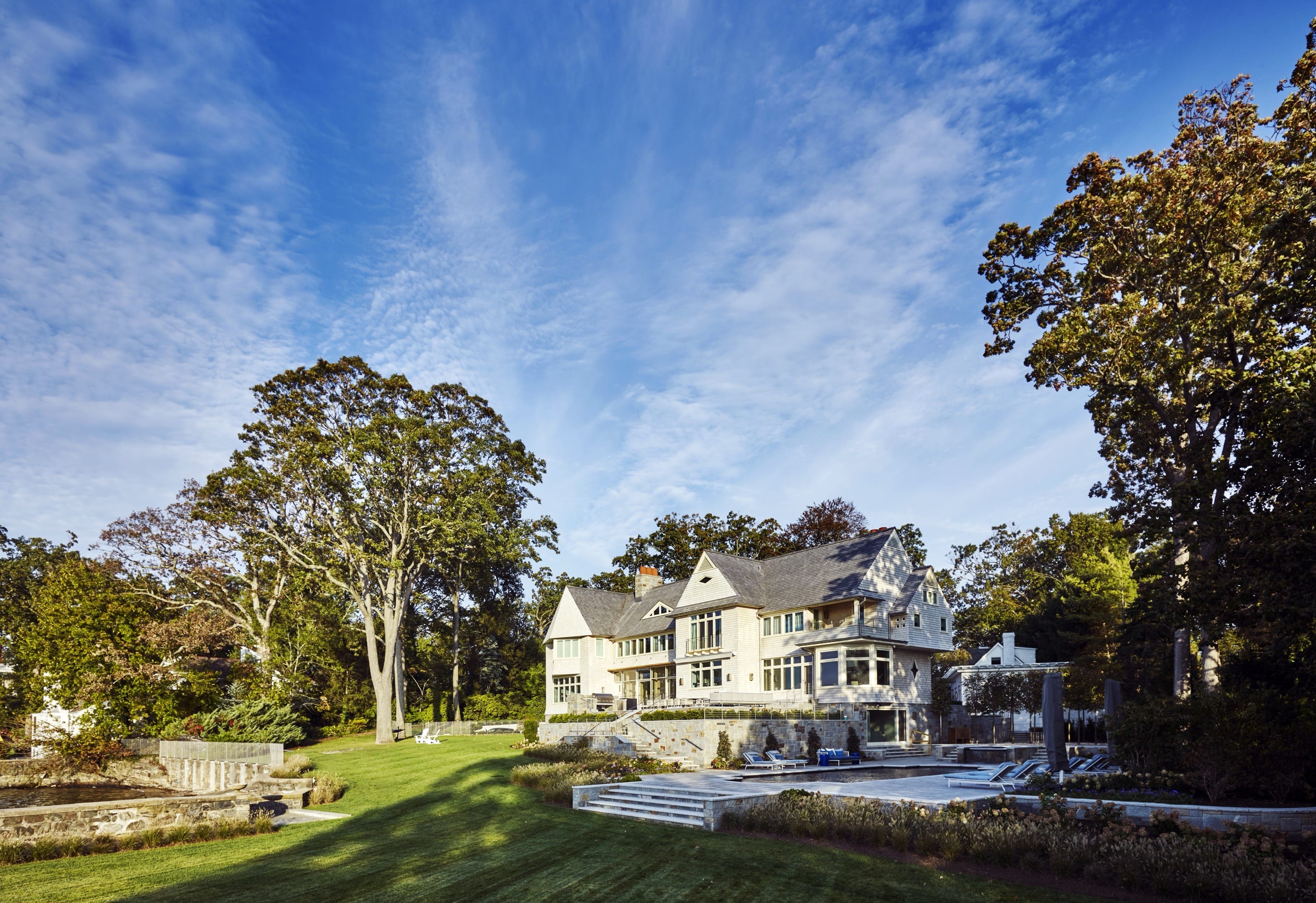 Exterior view of large home with landscaped yard.