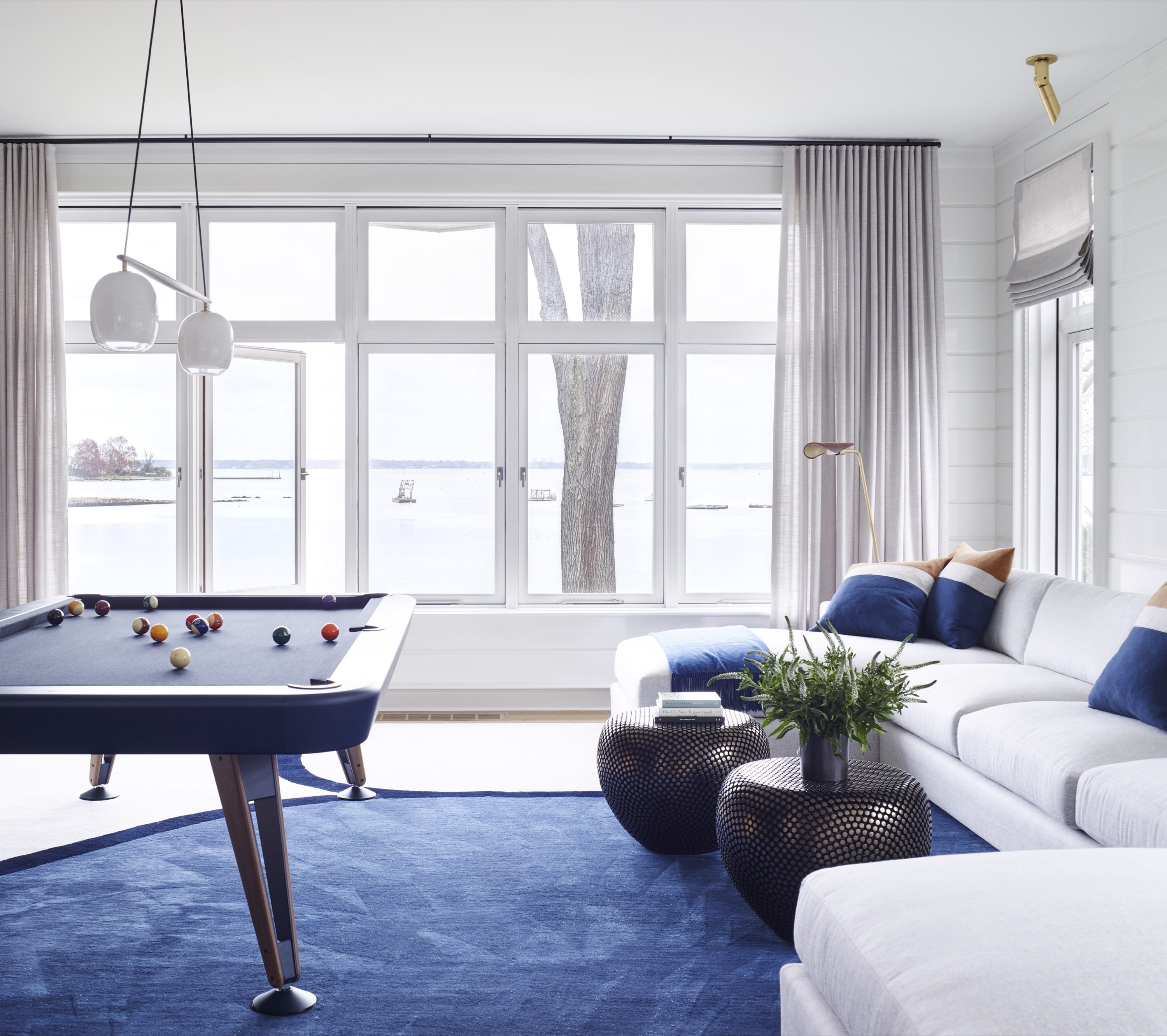 Game room with pool table and blue rug.