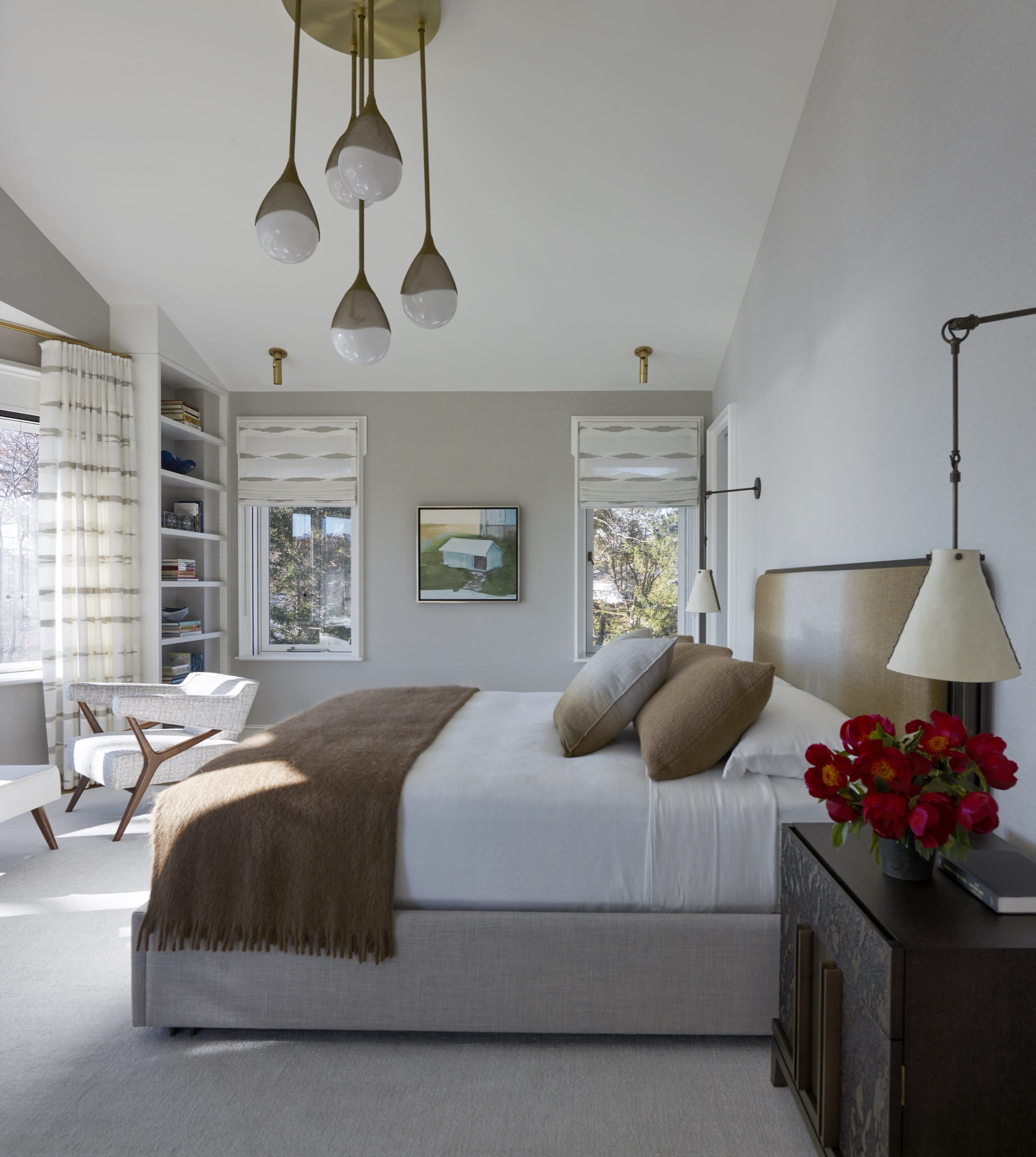 Bedroom with seating area and pendant lights.