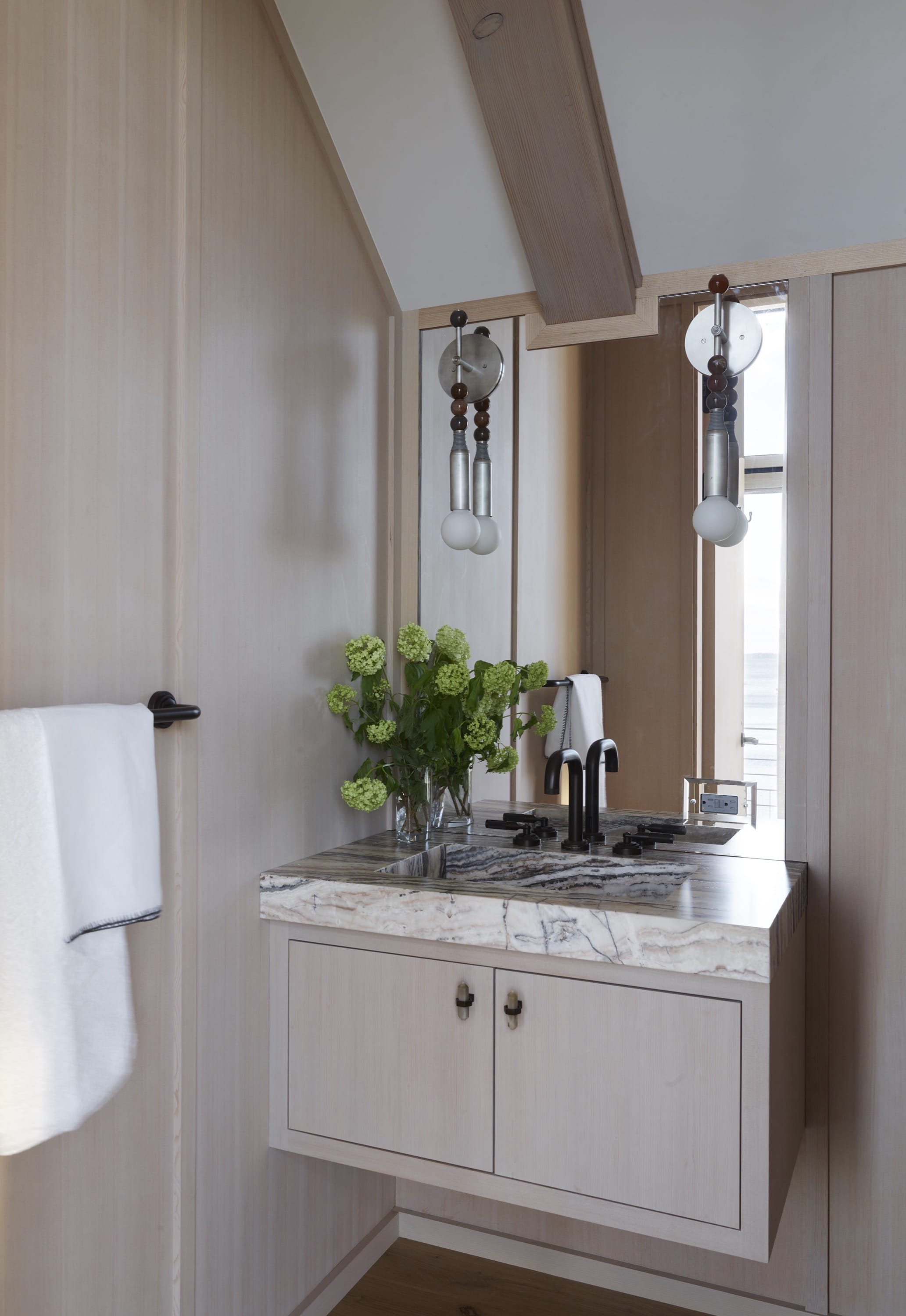 Laundry room with cabinets, sink, and natural light.