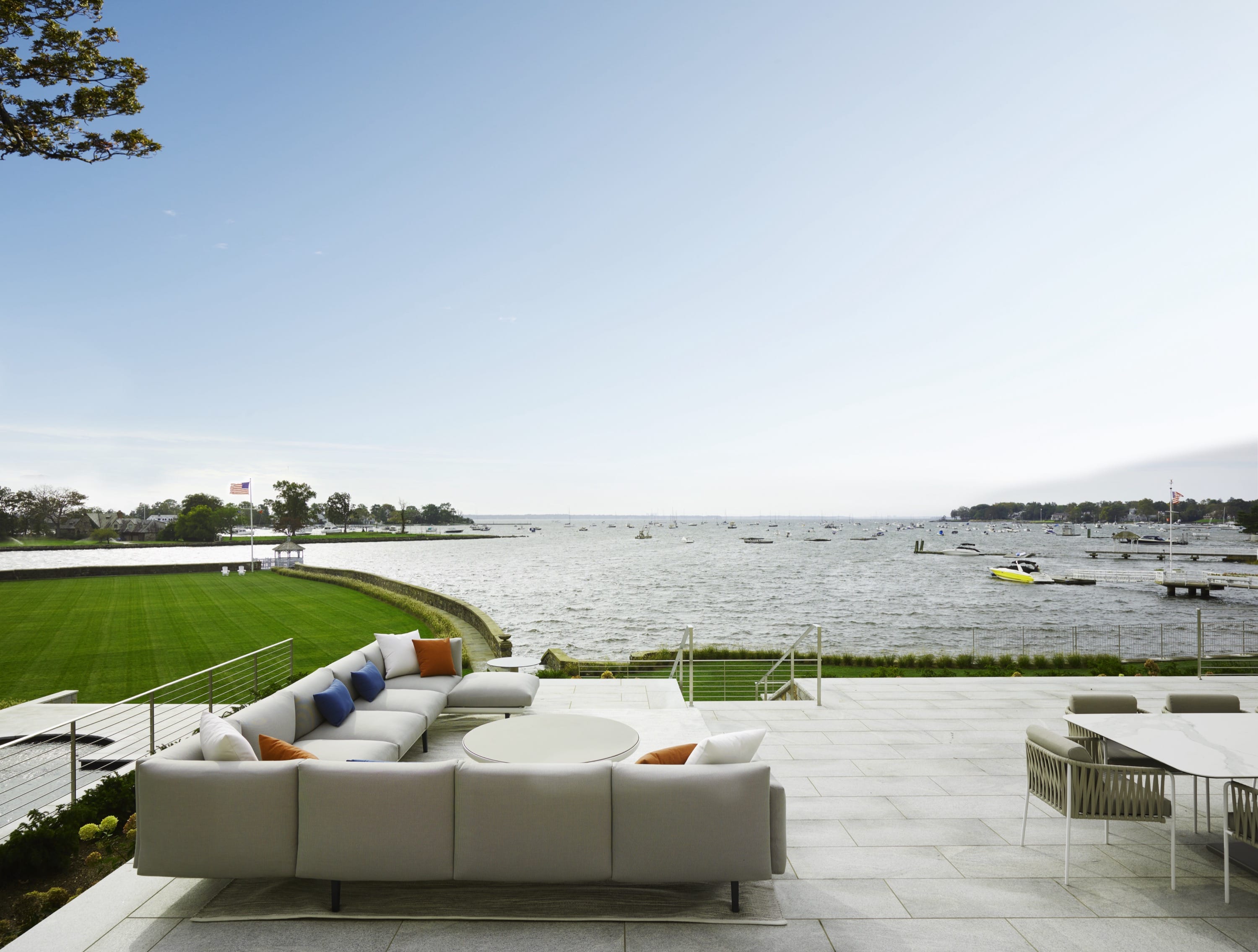 Backyard patio with seating and waterfront view.