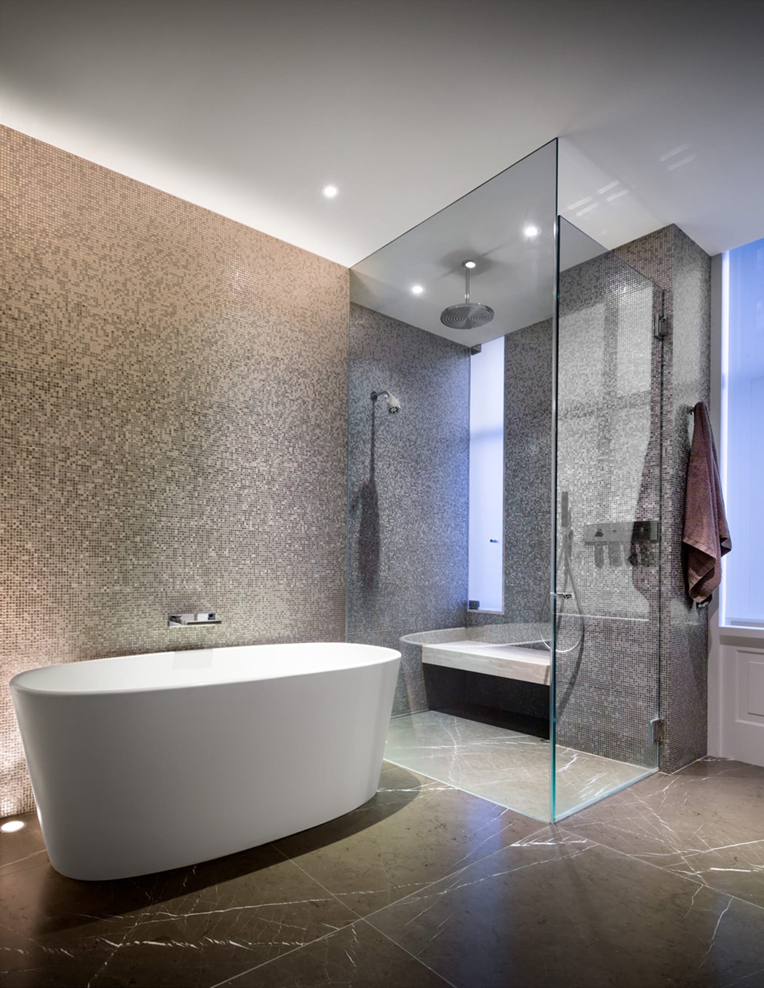 Bathroom with freestanding tub and glass shower.