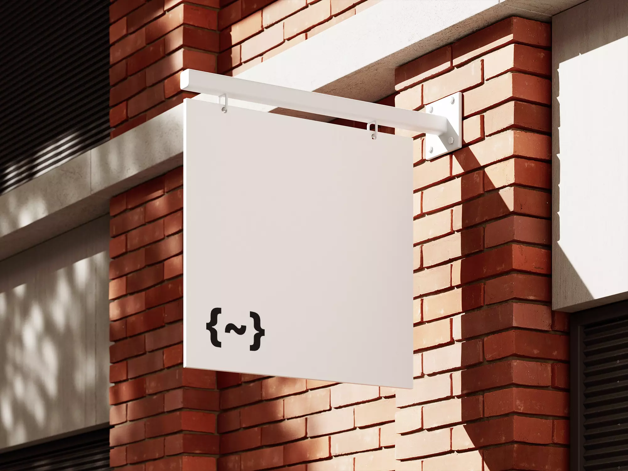 A white sign hanging from the side of a brick building.