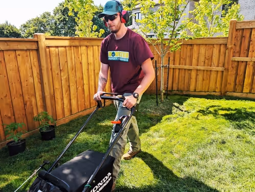 A male worker mowing lawn