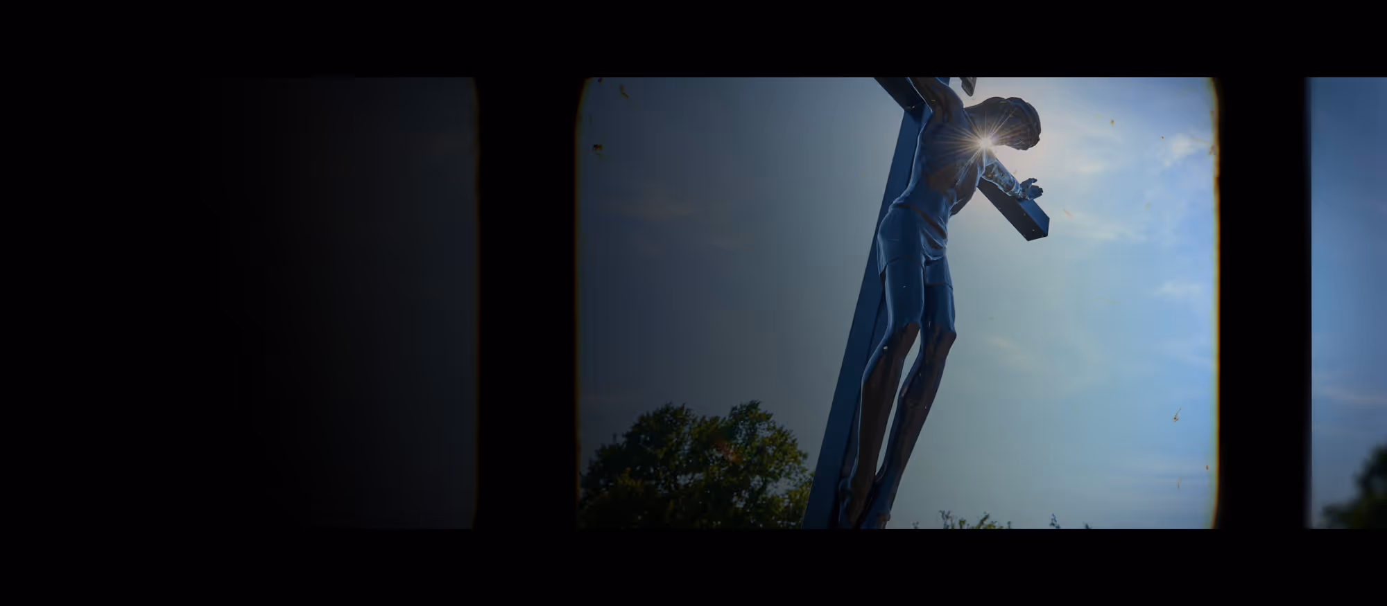 Film Reel with a Statue of Jesus on the Cross