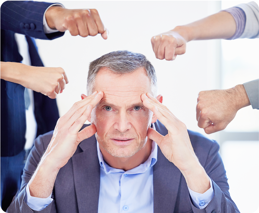 Person overwhelmed by pointing hands, illustrating decision-making bottlenecks that cause strategic misalignment and wasted spend.