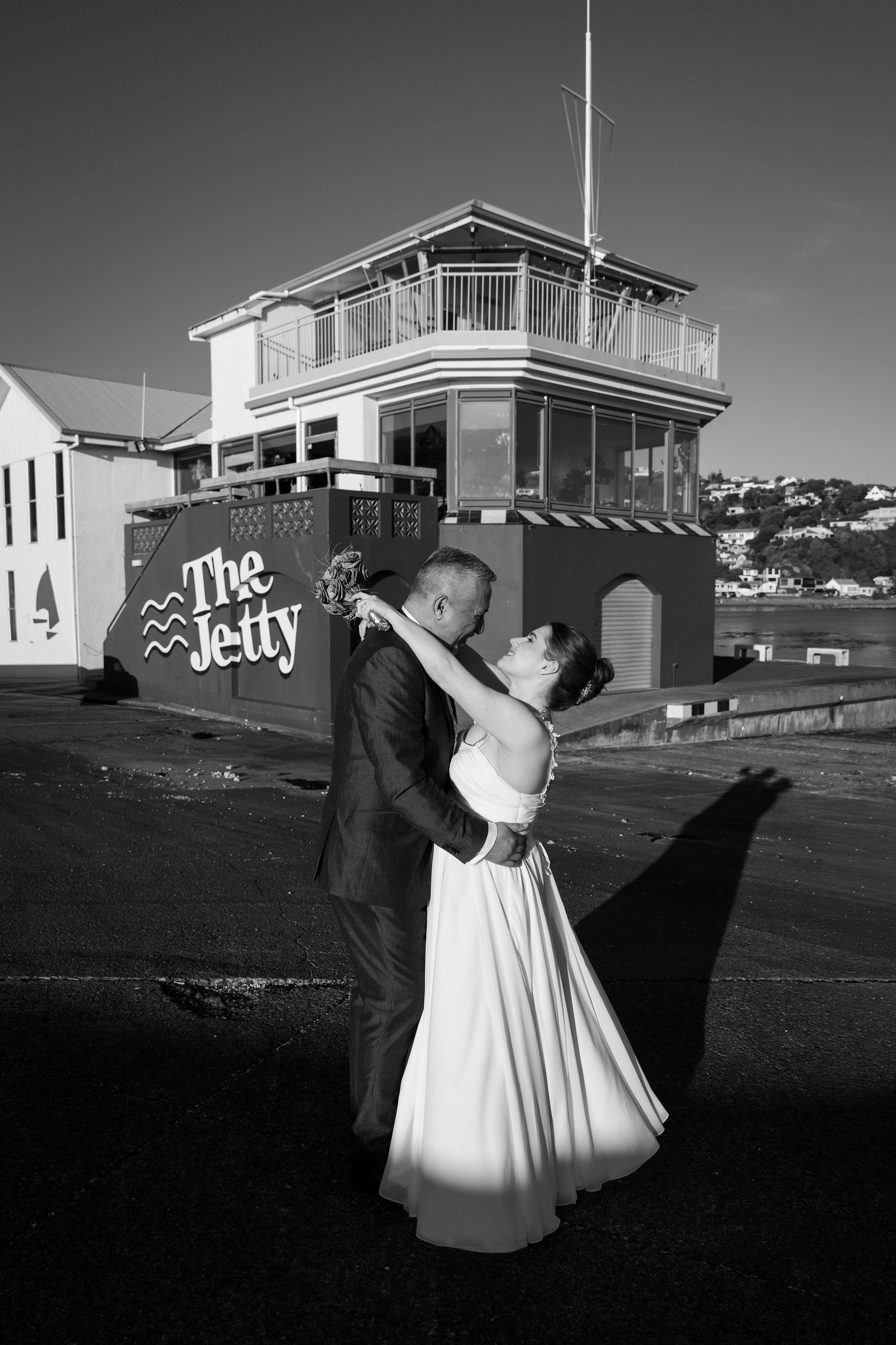 Black-and-white wedding portrait of a couple outside The Jetty