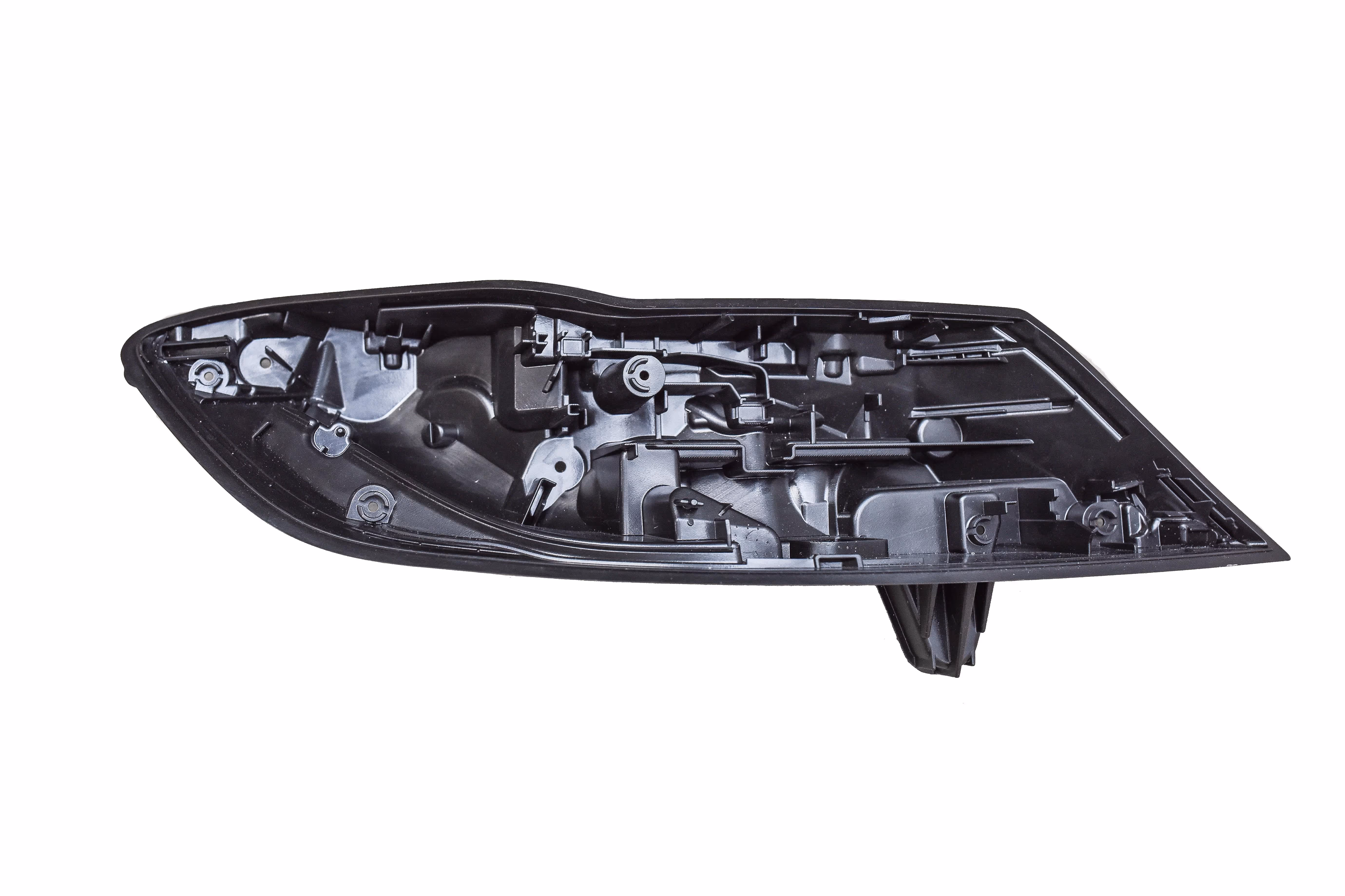 Black plastic inner housing of a car headlight assembly isolated on white background.