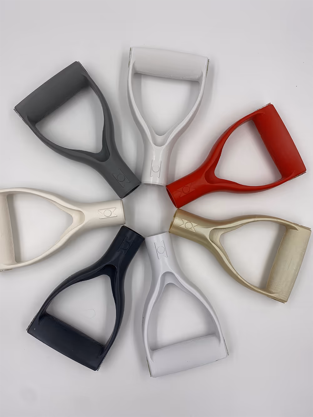 Six ergonomic D-shaped handles in various colors arranged in a circle on a white background.