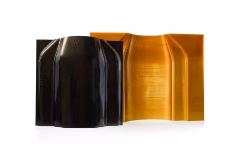 Two curved composite tooling molds, one black and one amber, on a white background.