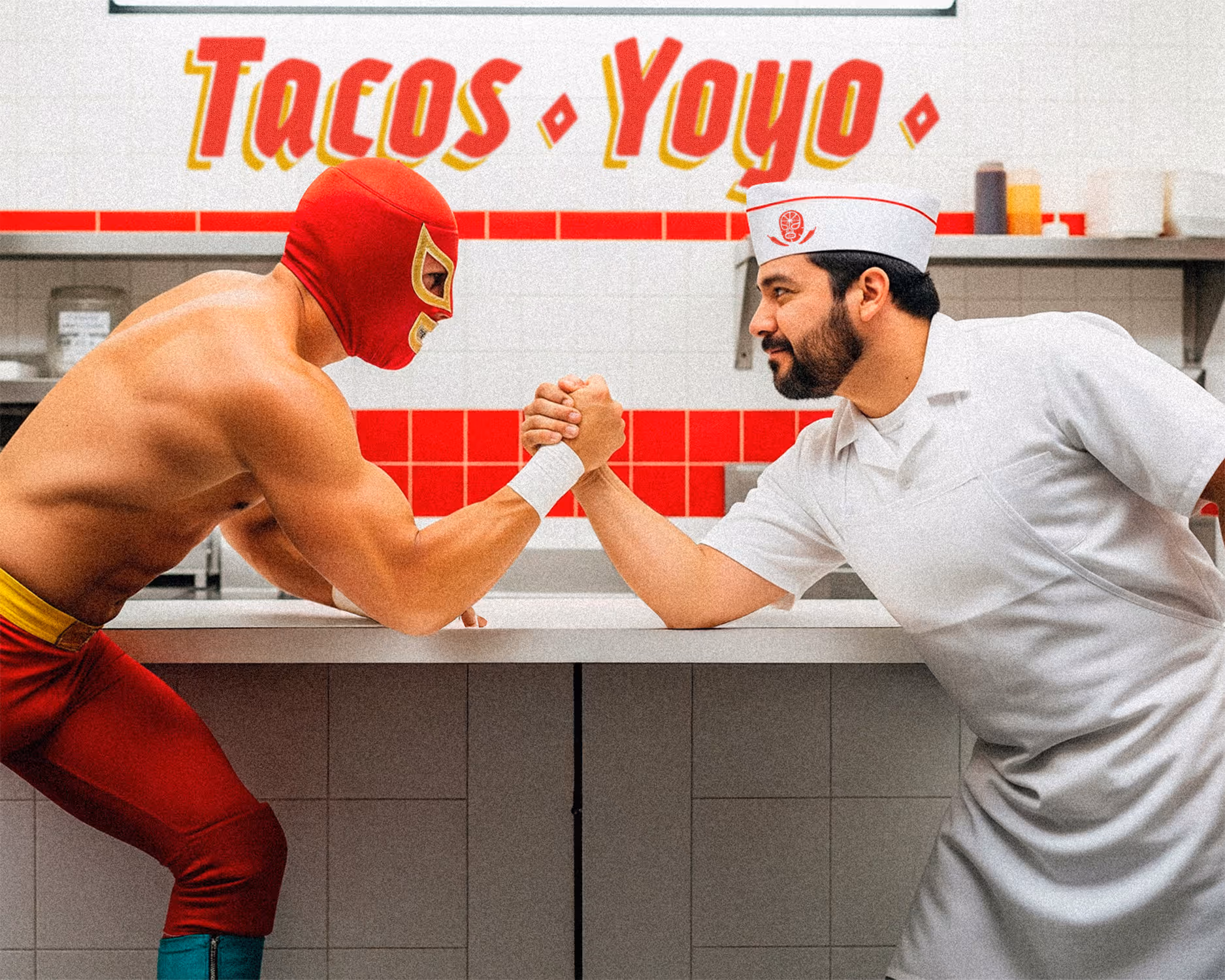 A masked luchador and a taquero in white uniform arm wrestling across a restaurant counter at Tacos Yoyo, with a red and white tiled wall and logo in the background.