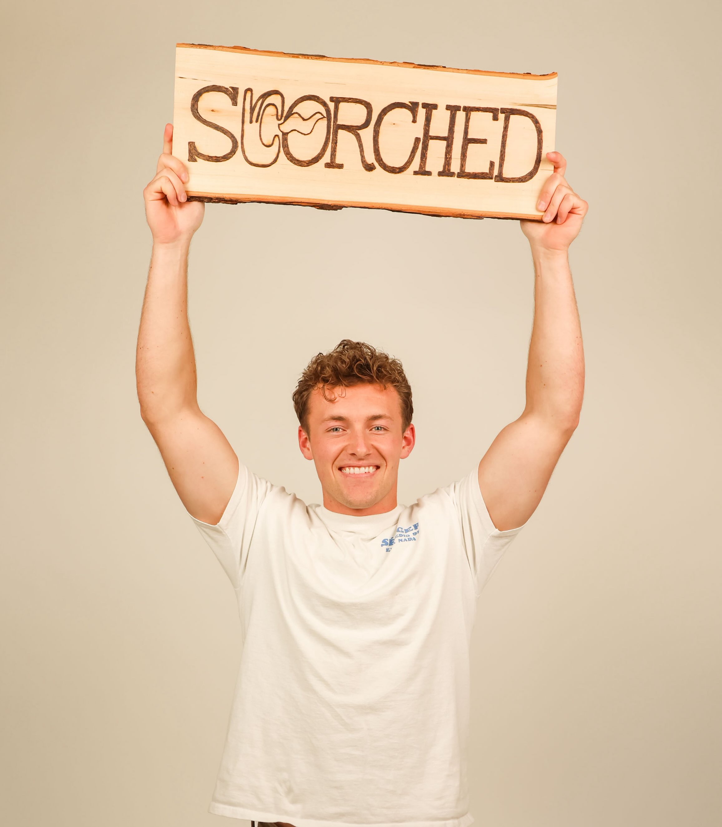 Man with Scorched WoodBurning Studio Sign