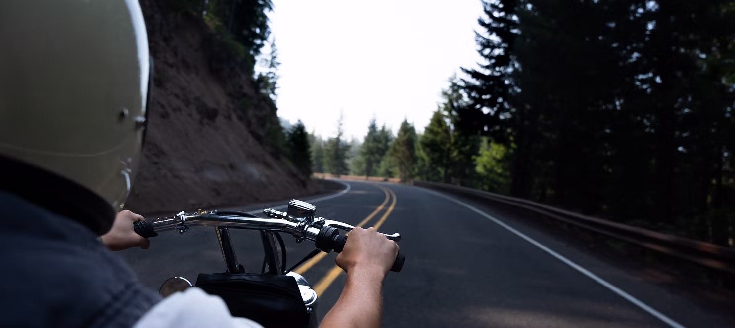 a person riding a motorcycle on a road