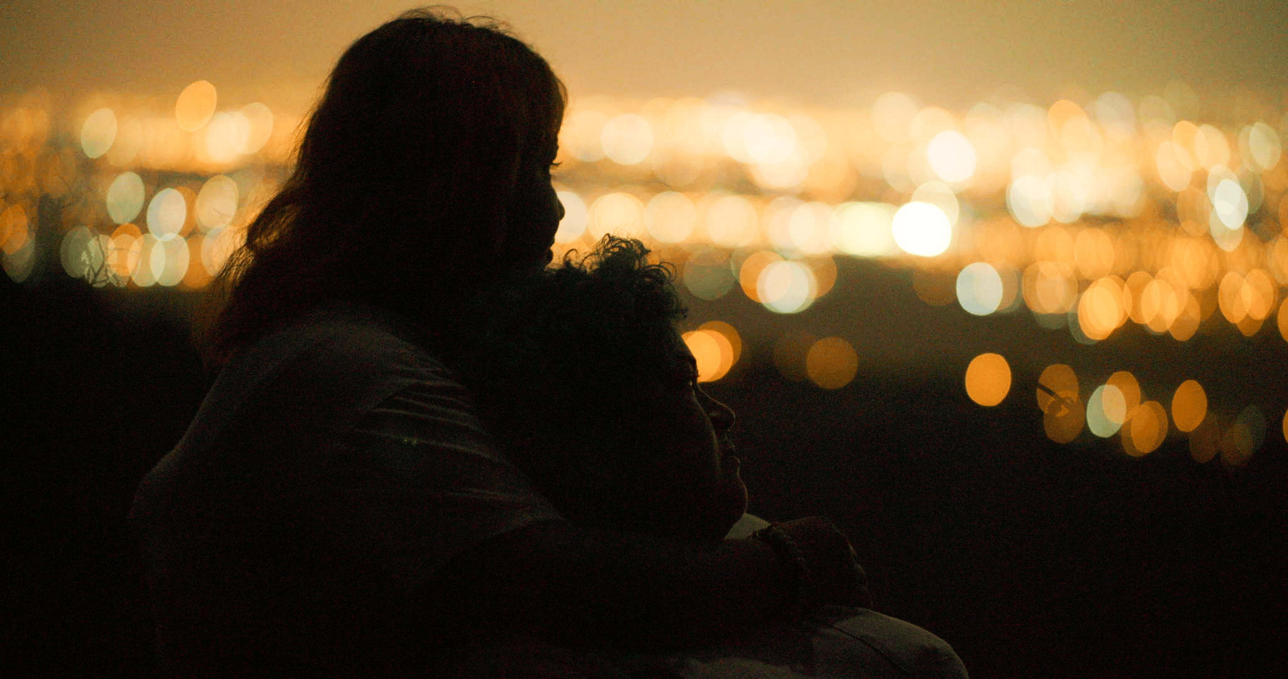 Two young women looking out at the horizon at night