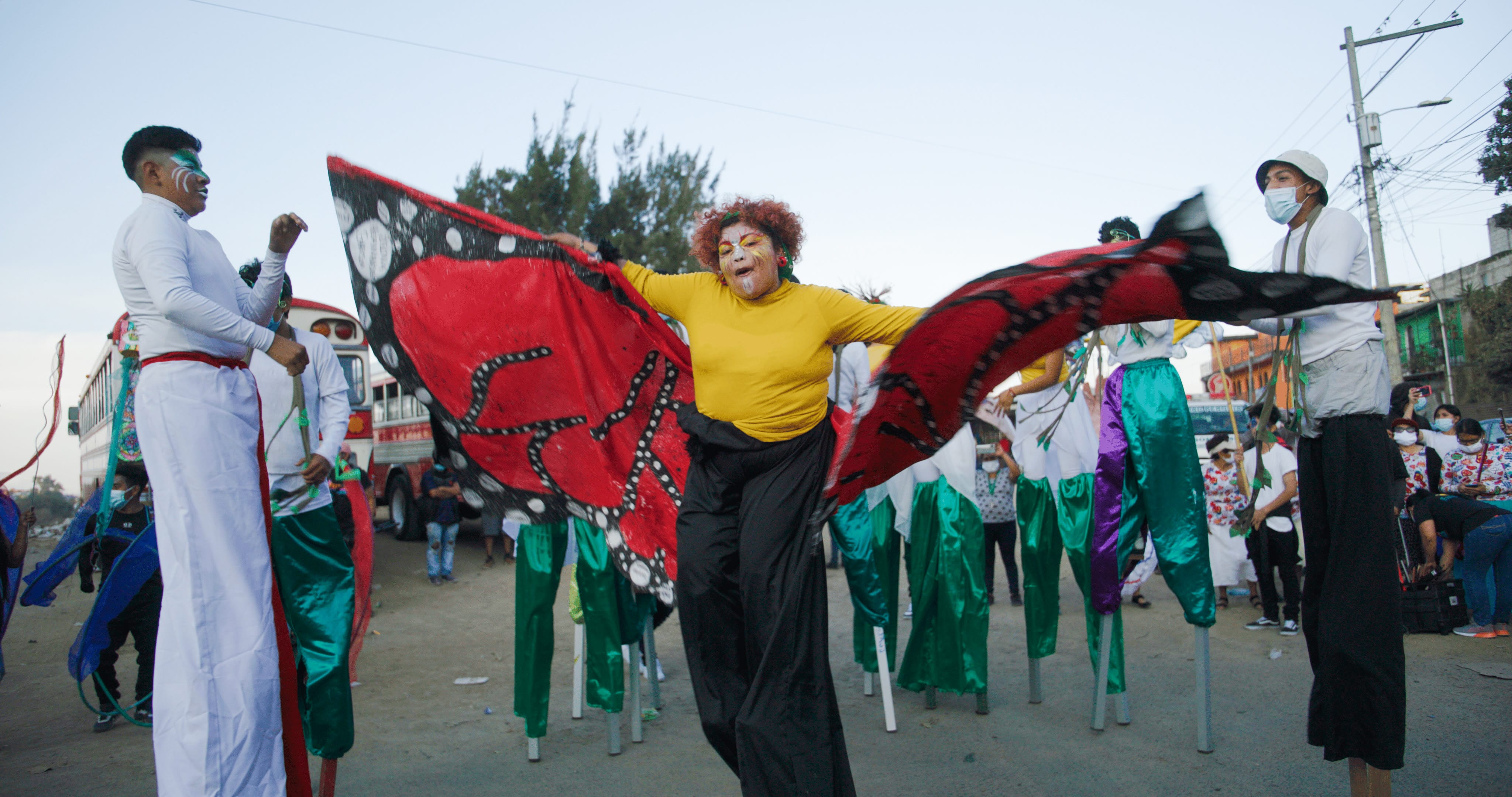 Young woman in costume and stilts performing