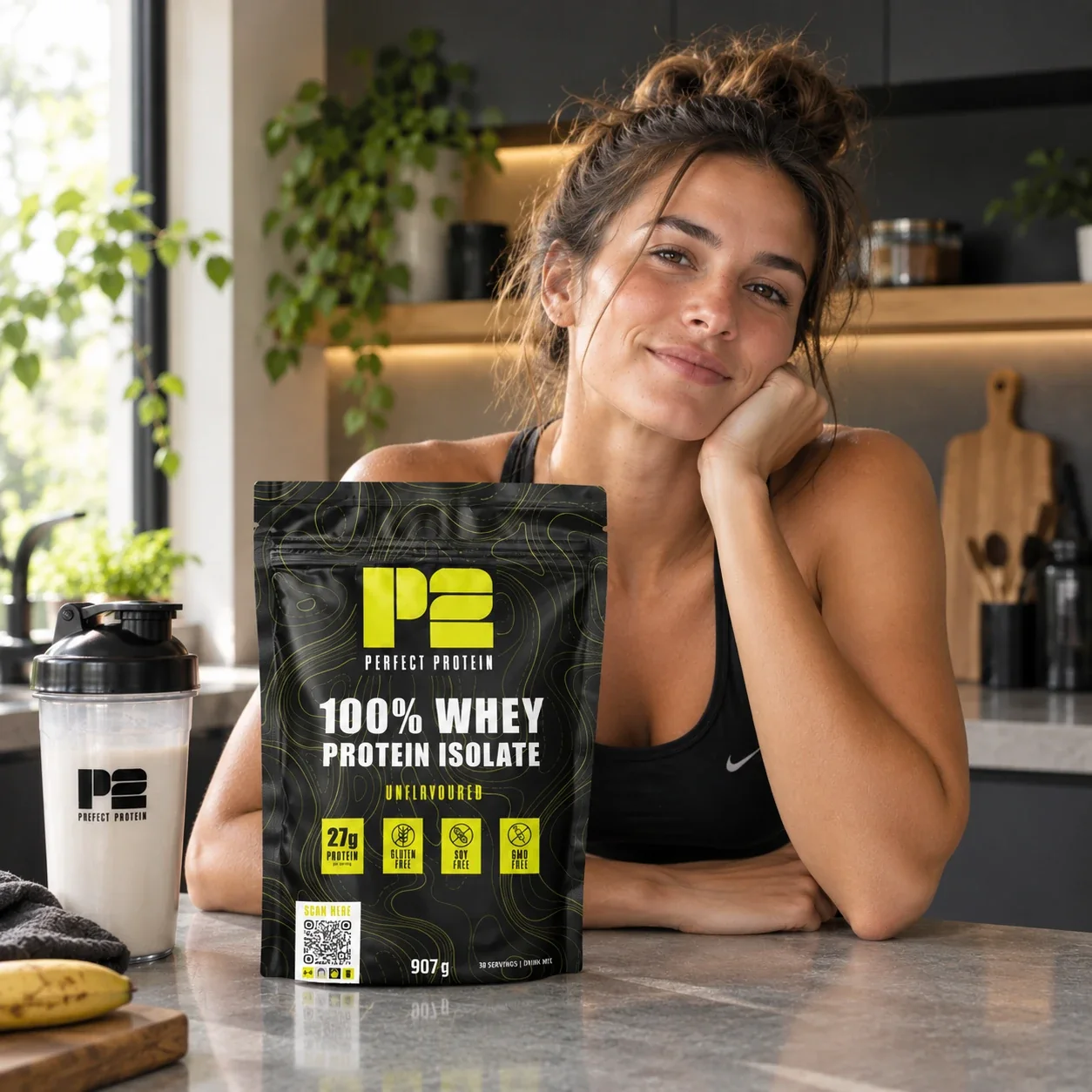A woman in her kitchen with a Perfect Protein whey pouch carrying a scan code, next to a shaker
