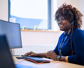 Woman working at desk with headset