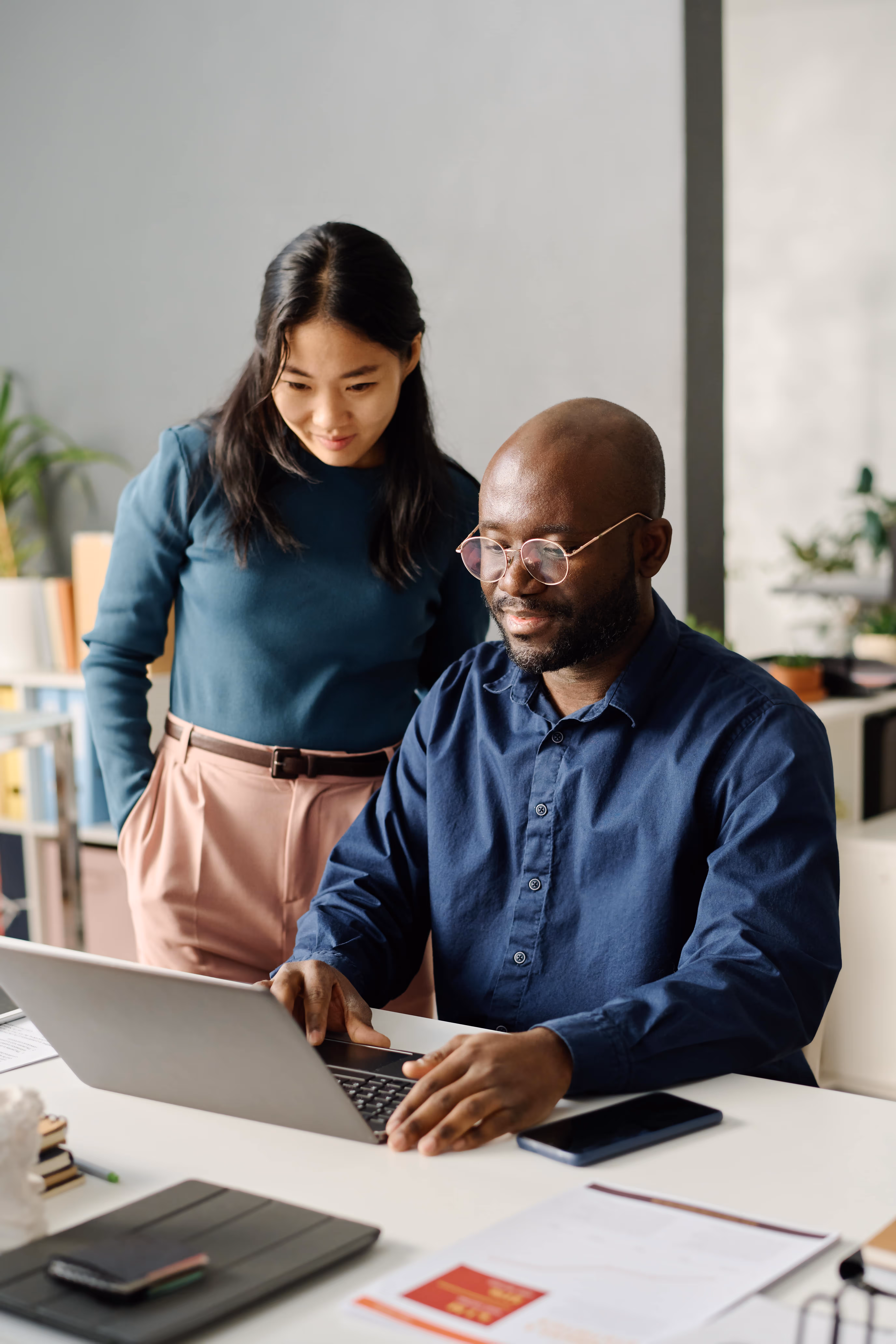 Image of two people working