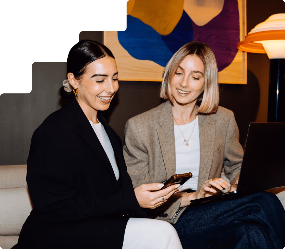 Image of 2 women looking excited over phone