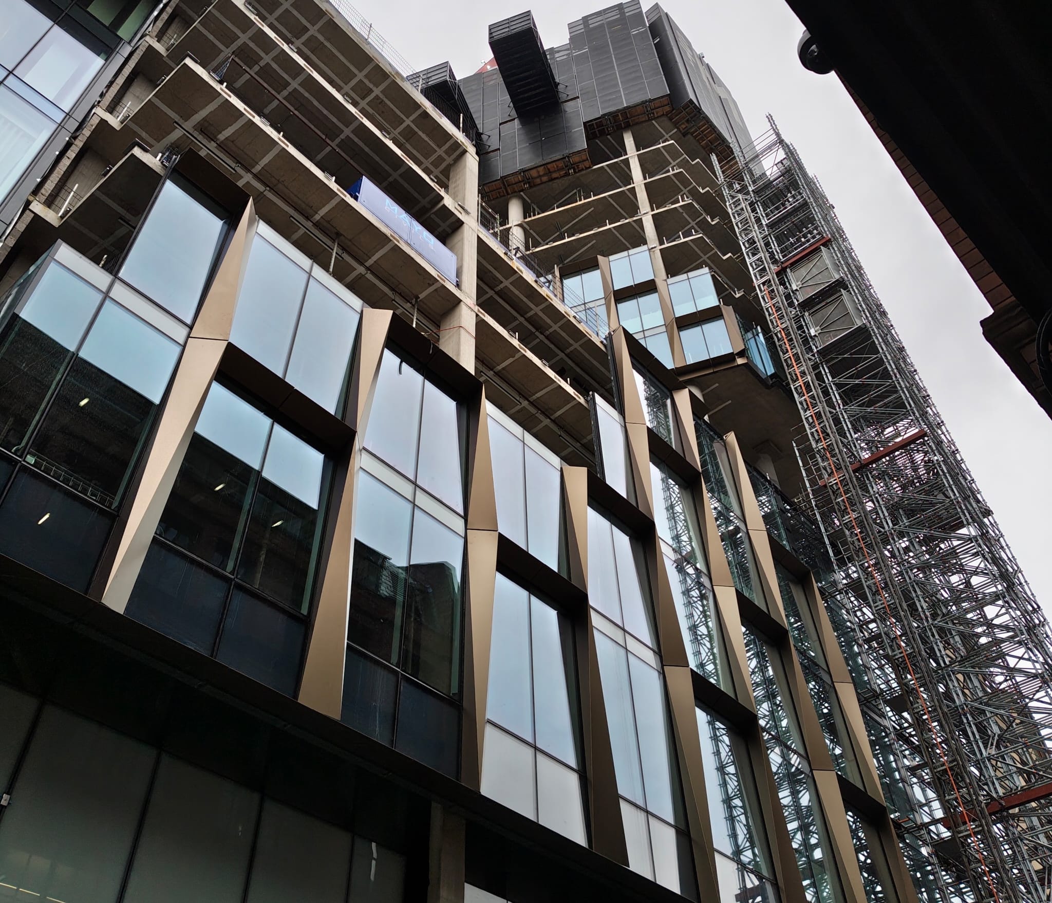 Construction nderway in Manchester, a tall office building with the windows half in