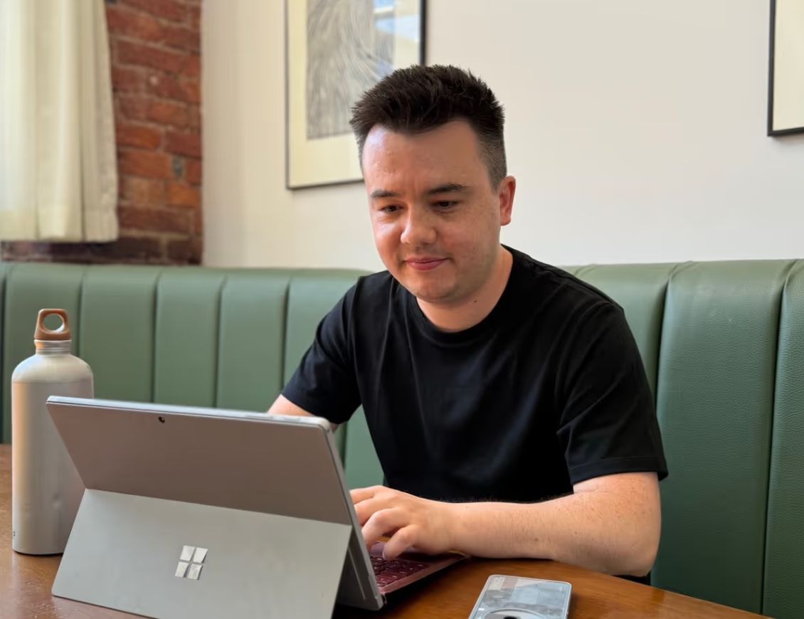 Me sat at a laptop doing construction marketing (or at least, pretending to for the benefit of photographer)