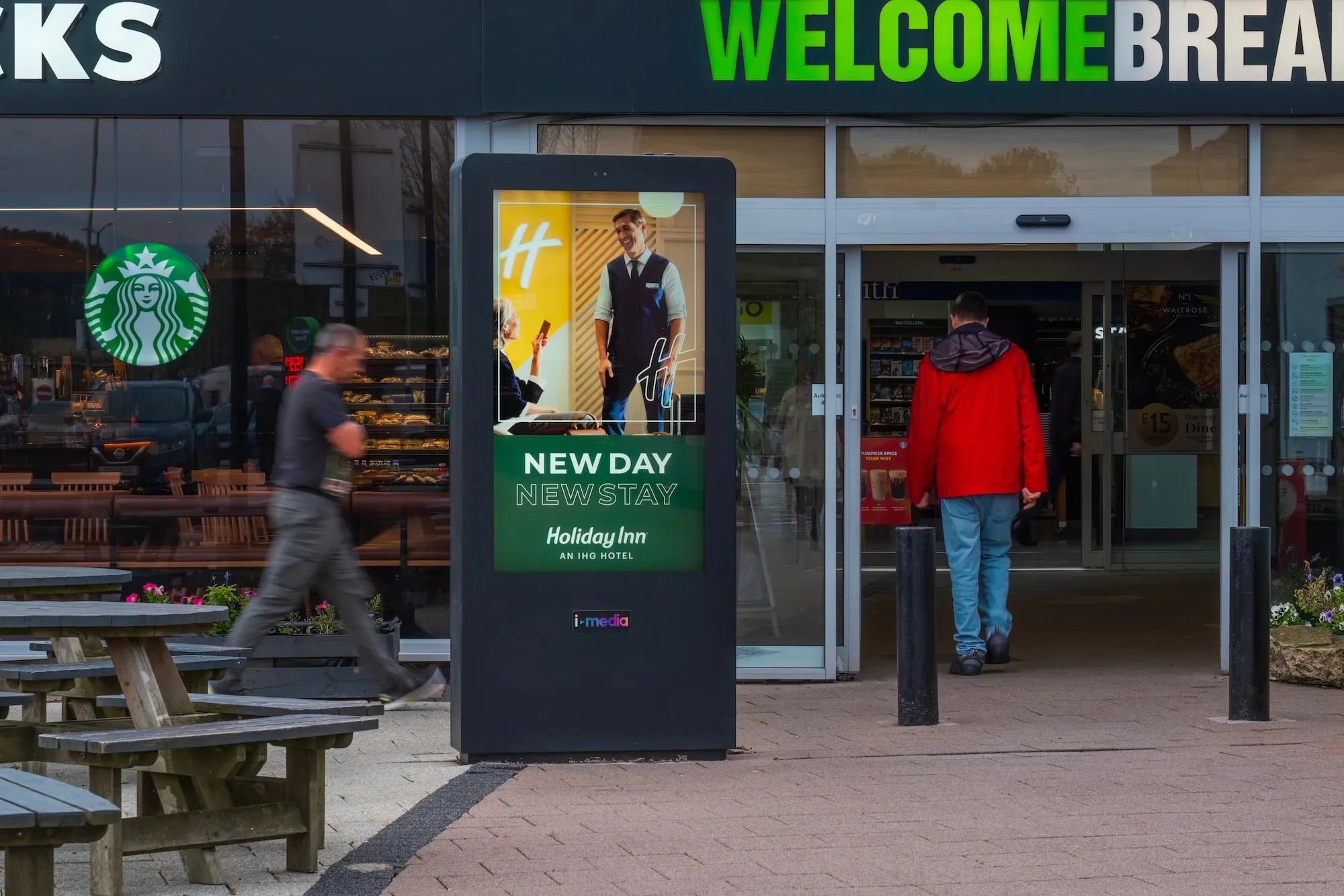 A Holiday Inn digital screen advertisement at Welcome Break services