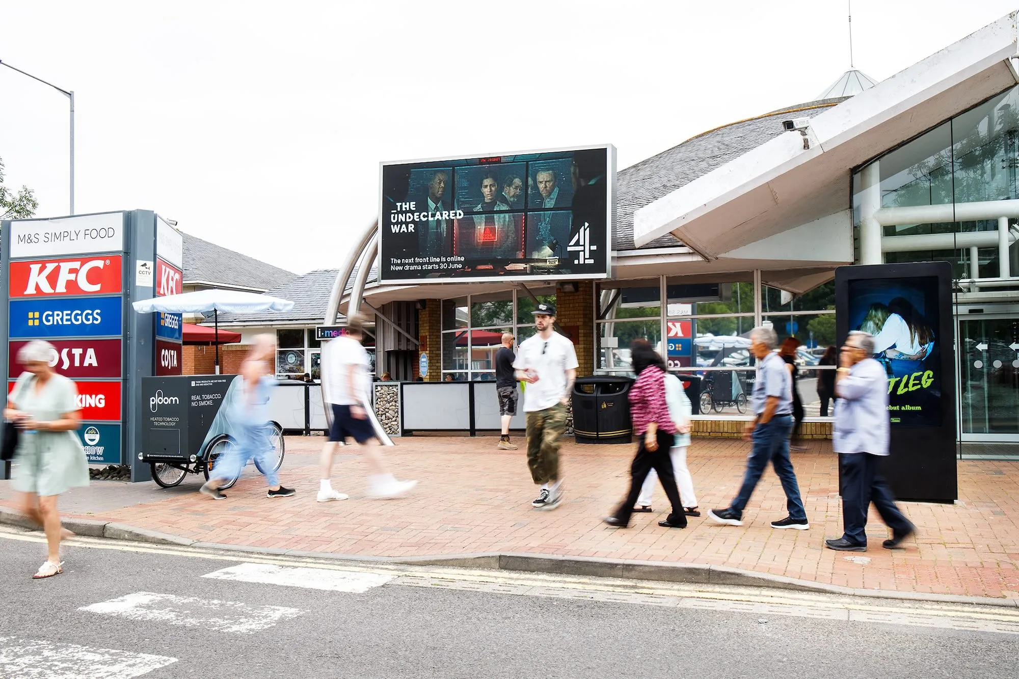 A Channel 4 advertisement displayed on a static screen at a motorway services.