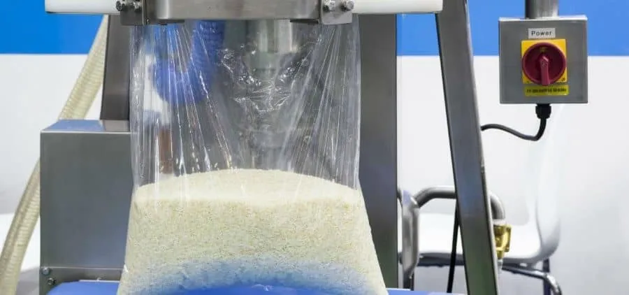 Grain being packaged into plastic pouch.