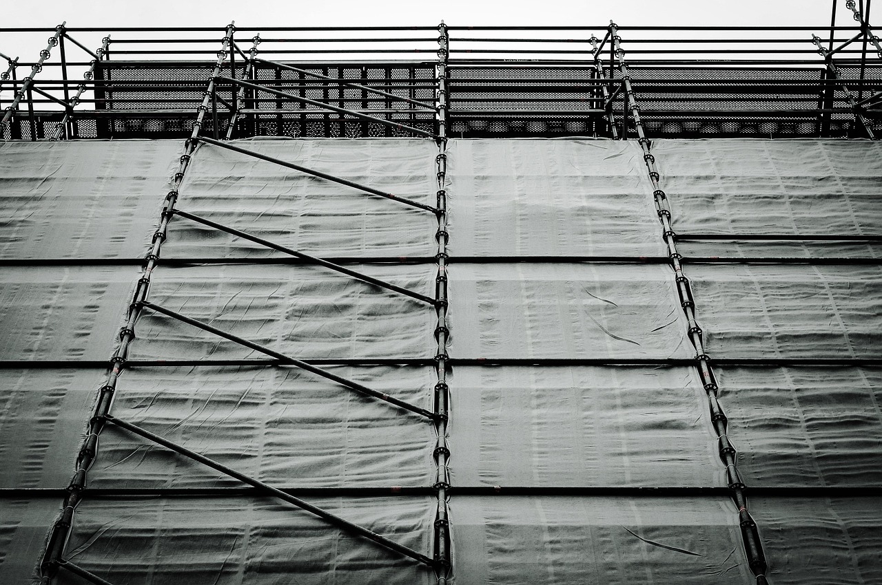 A building covered in scaffolding, showing a structure in the process of being carefully constructed or refined
