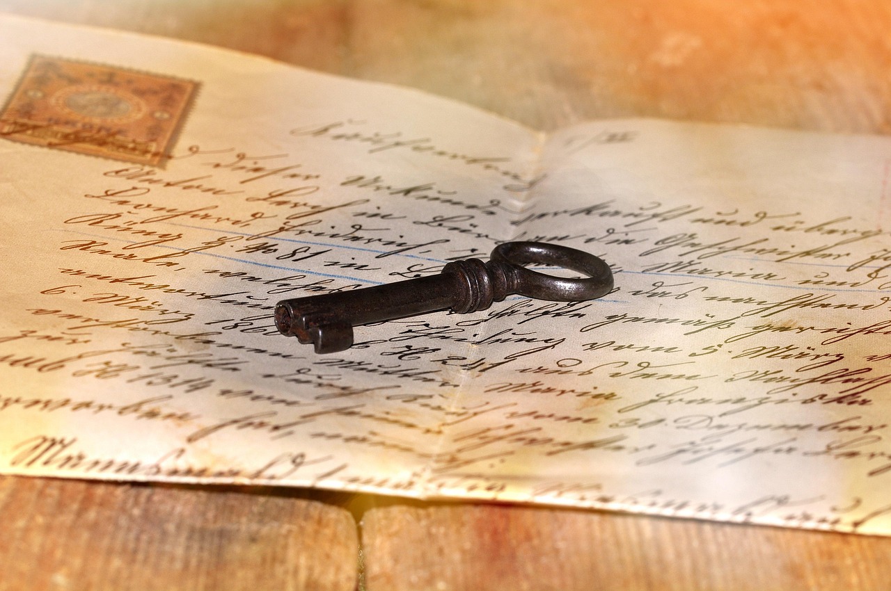 An old key resting on a handwritten letter