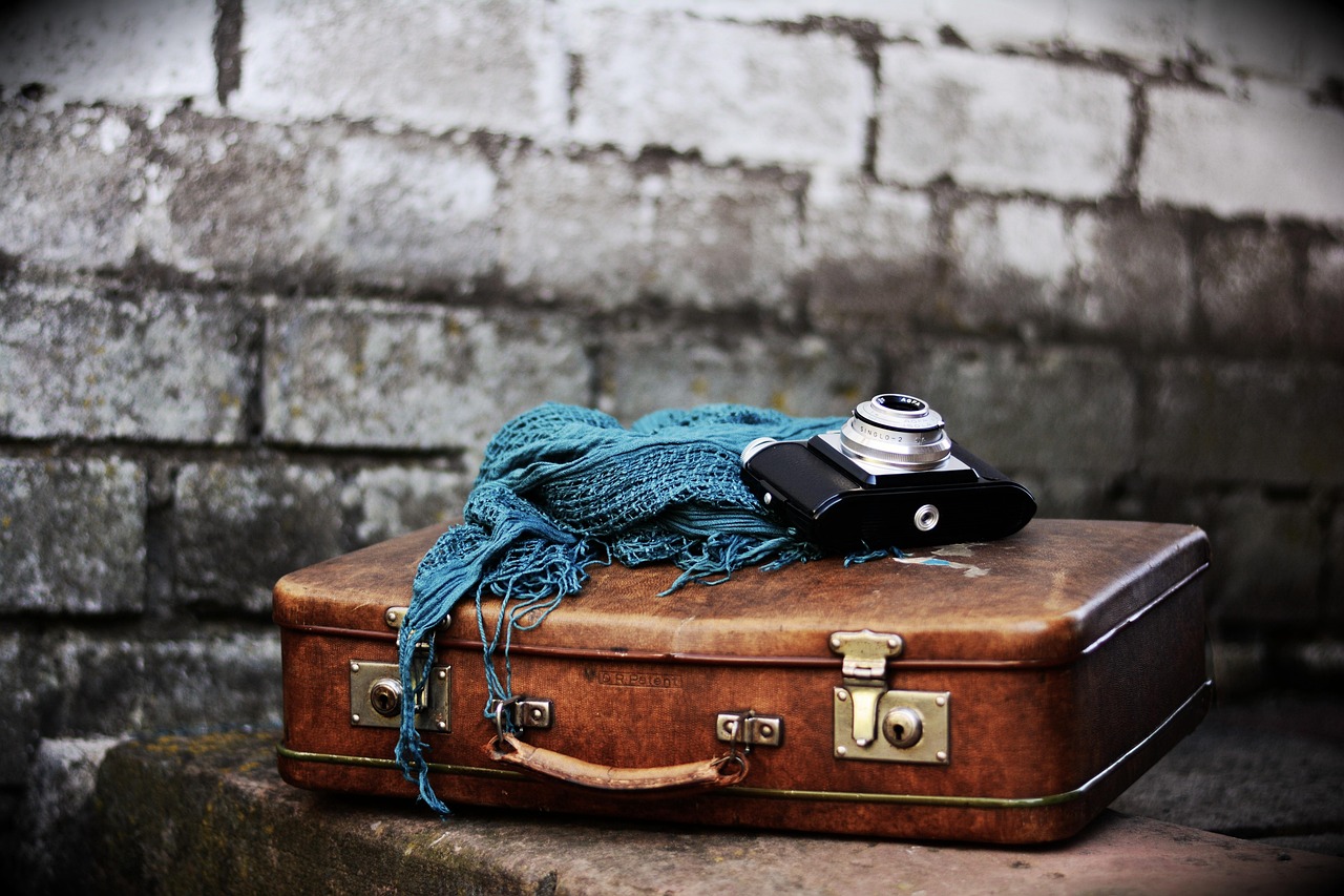 A vintage suitcase left on stone steps, representing the feeling of being stranded and remembering who helped