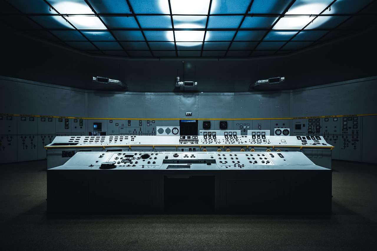 An empty control room with consoles and overhead lights, representing preparation, teamwork and calm coordination when something goes wrong