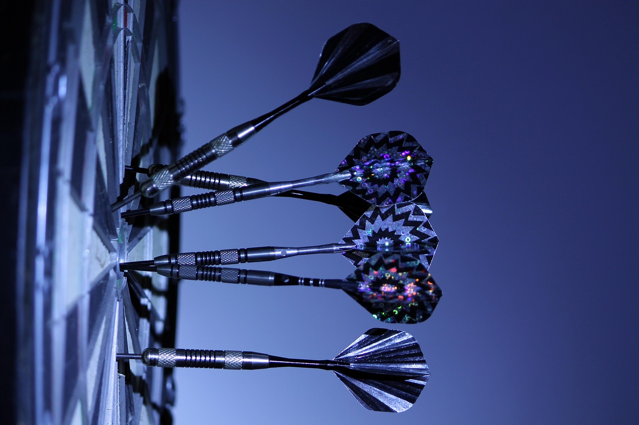Darts stuck in a dartboard, representing financial decisions made from hunches rather than checked facts.